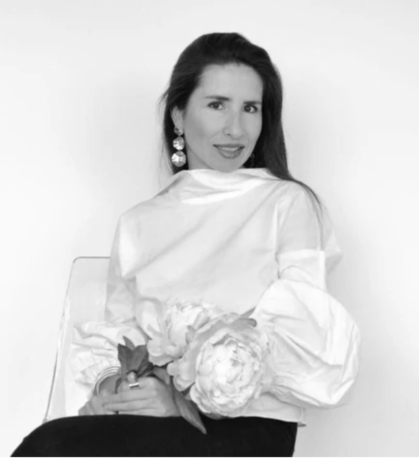 Woman in a white blouse holding flowers
