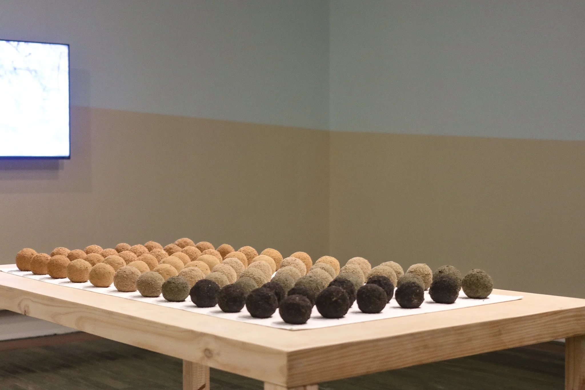 Tropical Blizz Ball Sale: After David Hammons (Gradient) | 2025 | sand, towel & wood | 74” x 40” x 30.5” 
