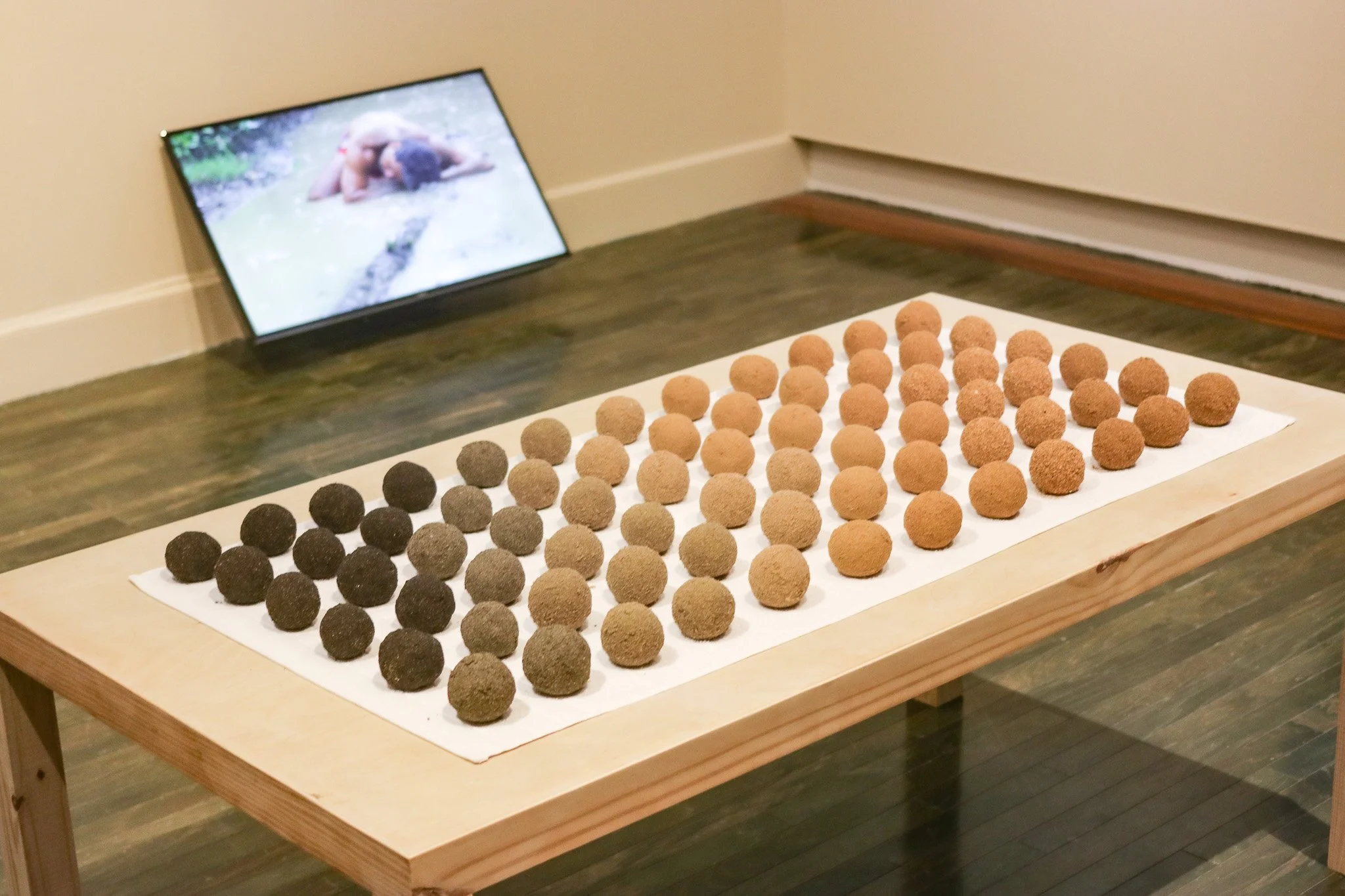 Tropical Blizz Ball Sale: After David Hammons (Gradient) | 2025 | sand, towel & wood | 74” x 40” x 30.5” 