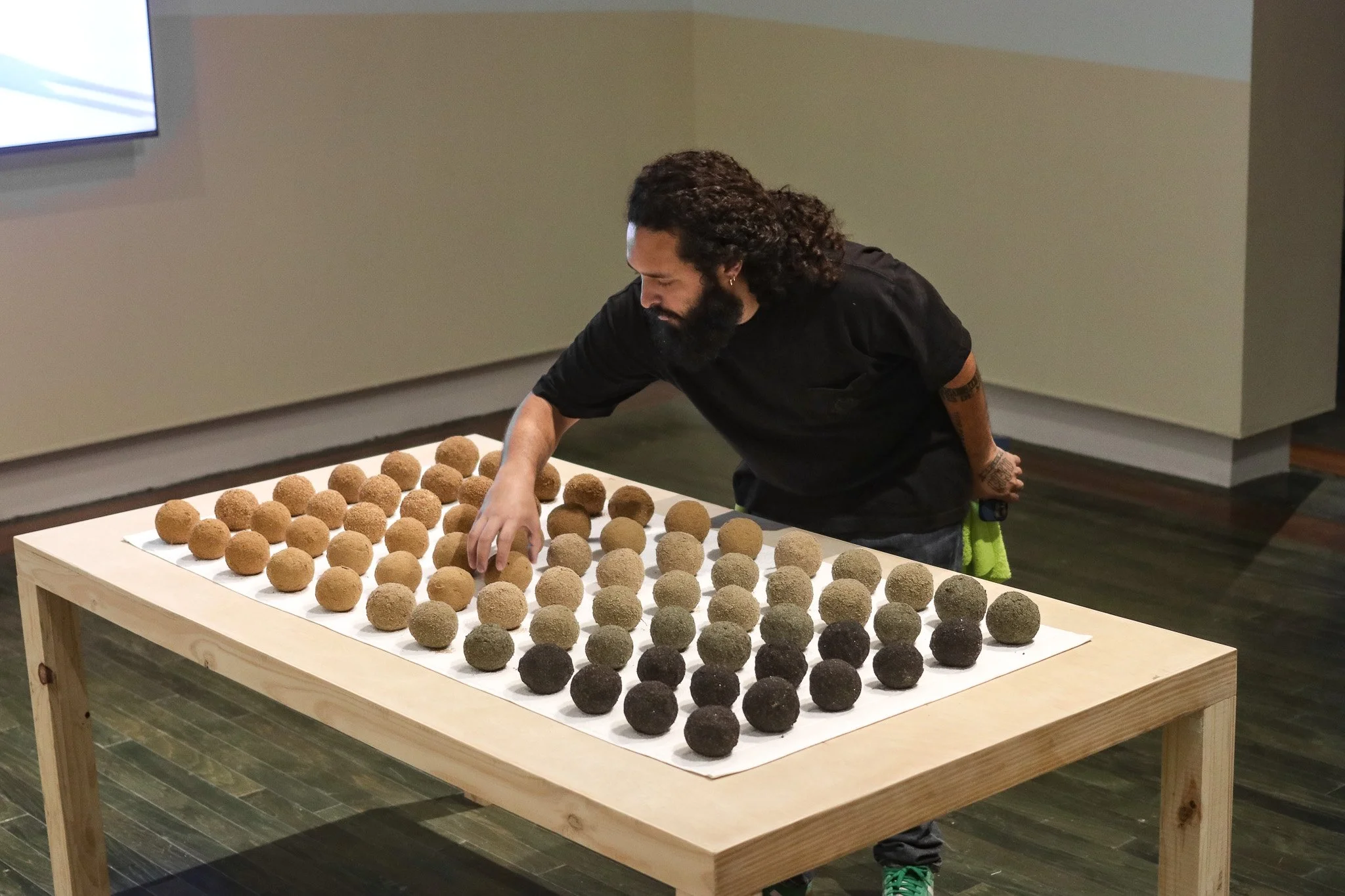 Tropical Blizz Ball Sale: After David Hammons (Gradient) | 2025 | sand, towel & wood | 74” x 40” x 30.5” 