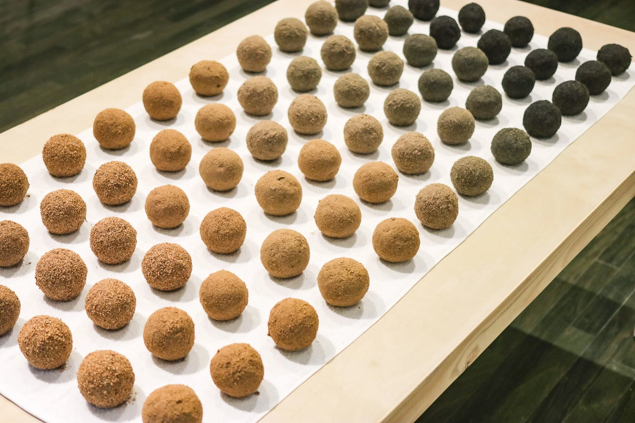 Tropical Blizz Ball Sale: After David Hammons (Gradient) | 2025 | sand, towel & wood | 74” x 40” x 30.5” 