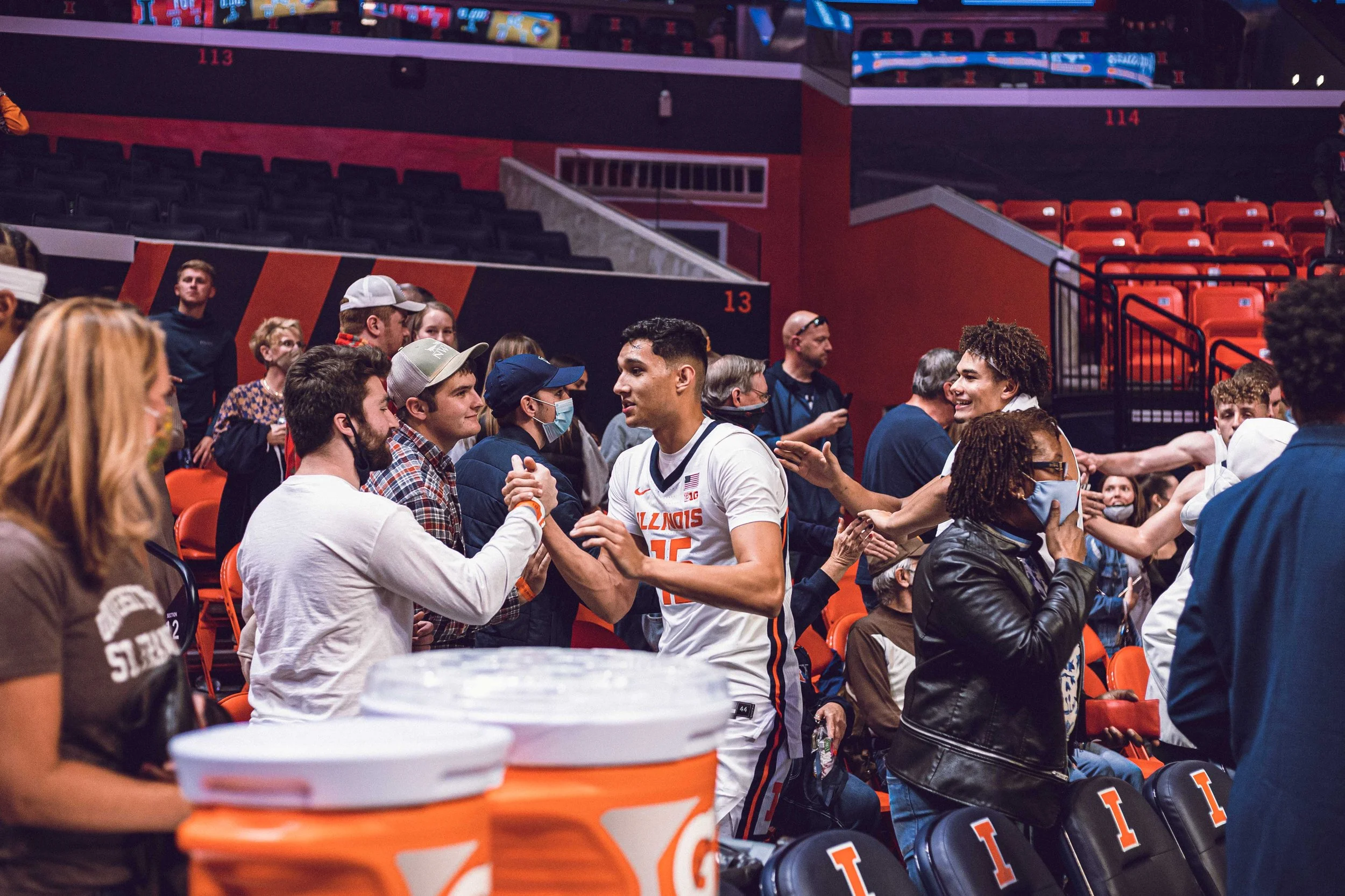 Joey Hartz, designer, and RJ Melendez, former Illini basketball player, meeting after a home basketball game.