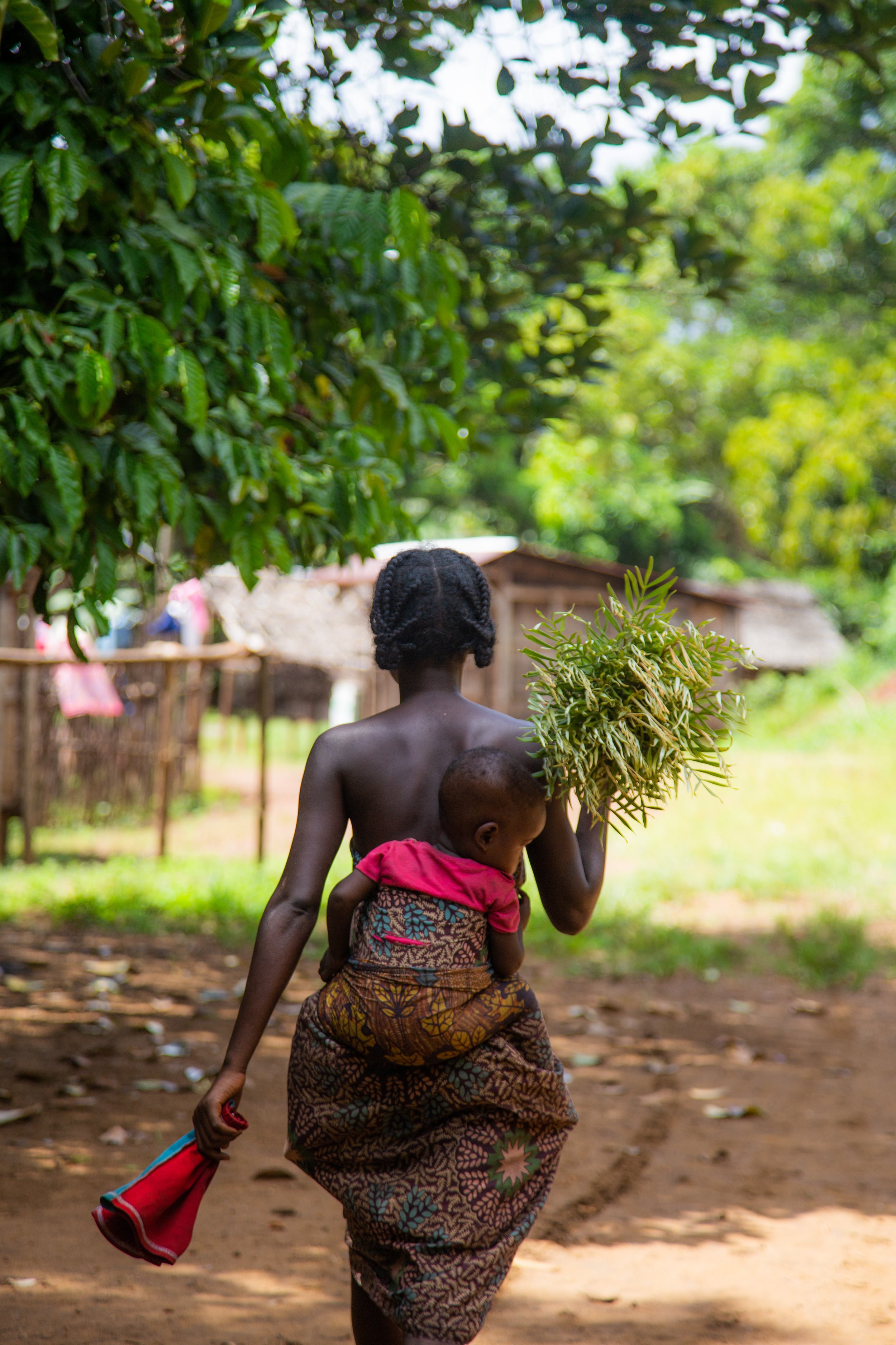 woman seen from behind, baby on her back