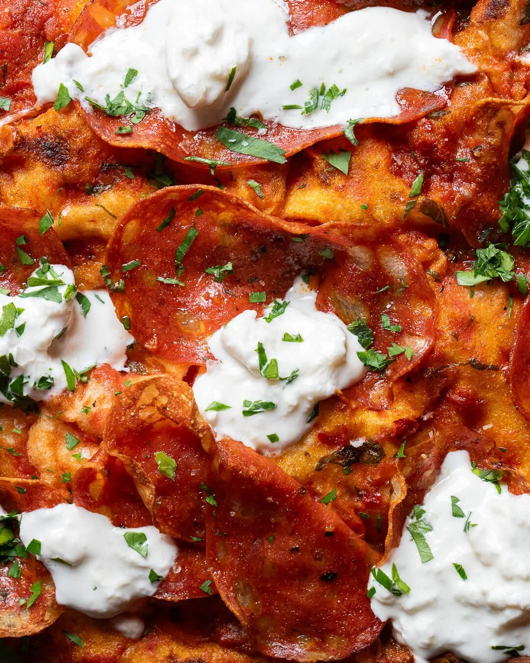 Close-up of a plate of pepperoni pizza with ricotta and parsley, photographed by a product photography Glasgow service.