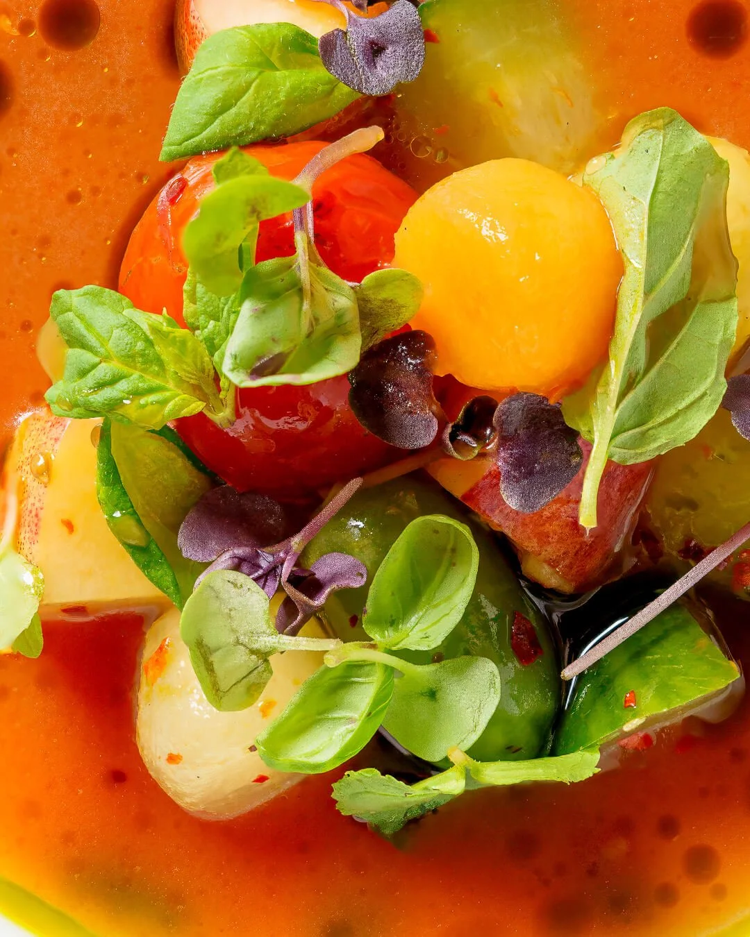 Close-up of a colorful watermelon fruit salad garnished with herbs and microgreens, taken by a product photography Scotland service.