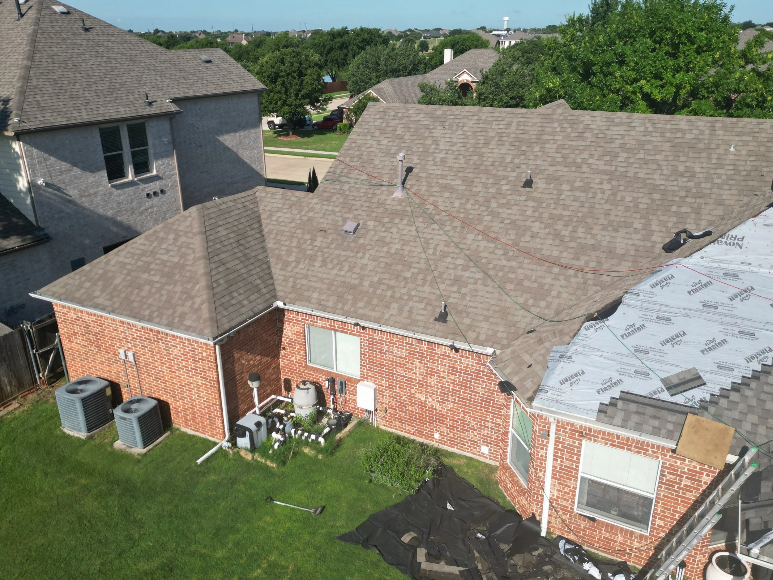 Oranssi technician working on a roof project