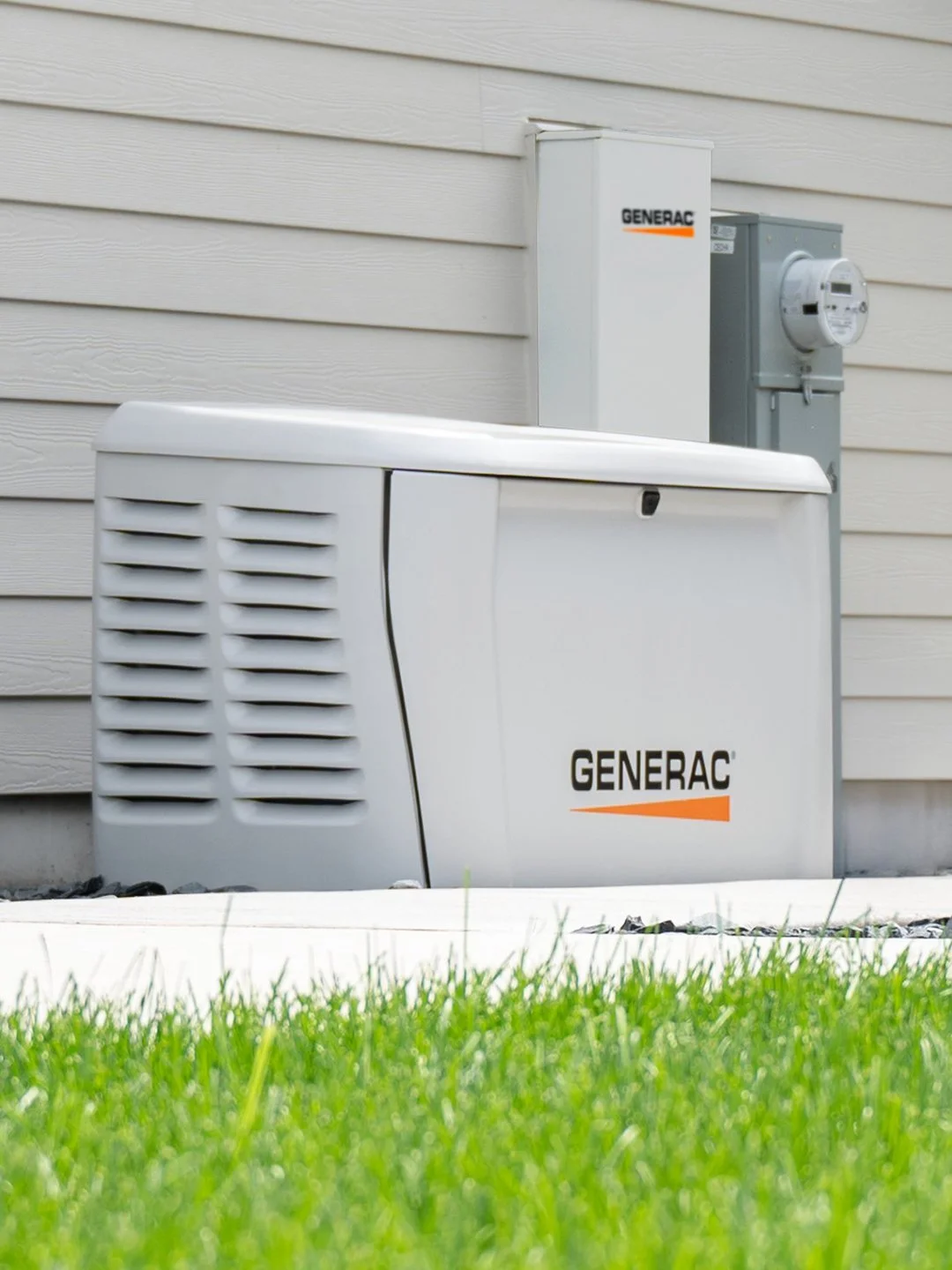 Generac generator installed in a backyard, positioned on a concrete pad surrounded by grass, ready to provide reliable backup power during outages.
