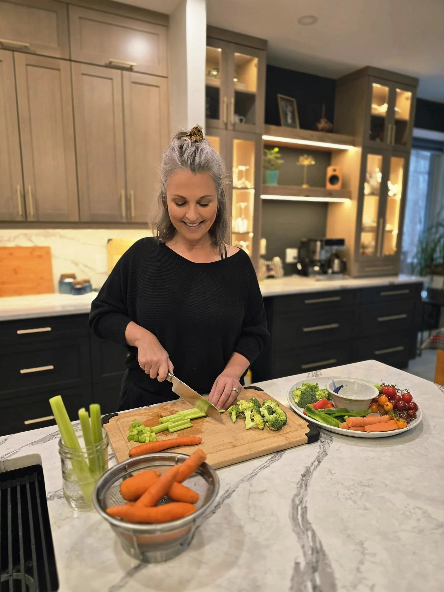 Shannon Buchko, Registered Holistic Nutritionist in Regina Saskatchewan, preparing fresh vegetables in a kitchen