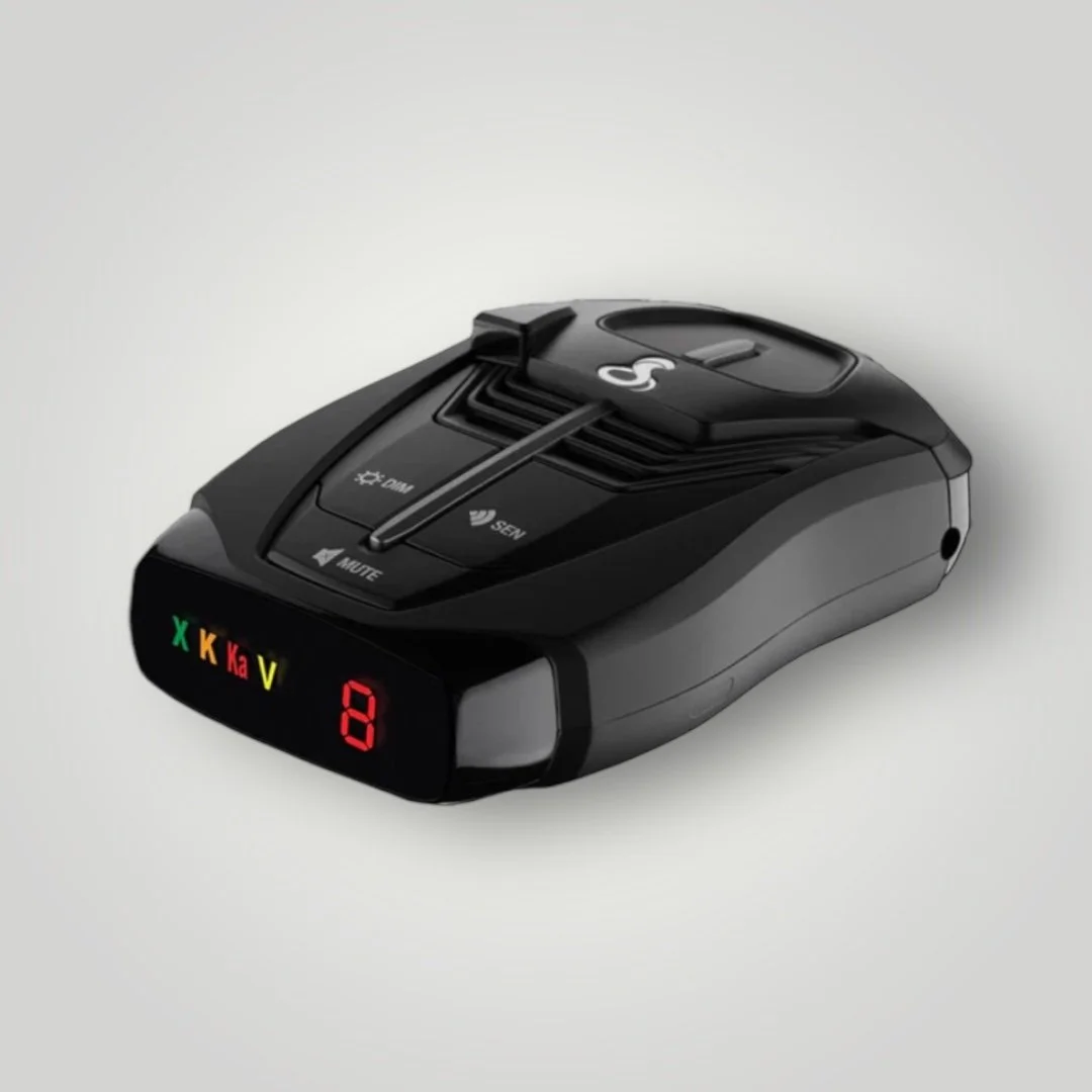 Radar detector with digital display, multiple buttons, and frequency indicators.