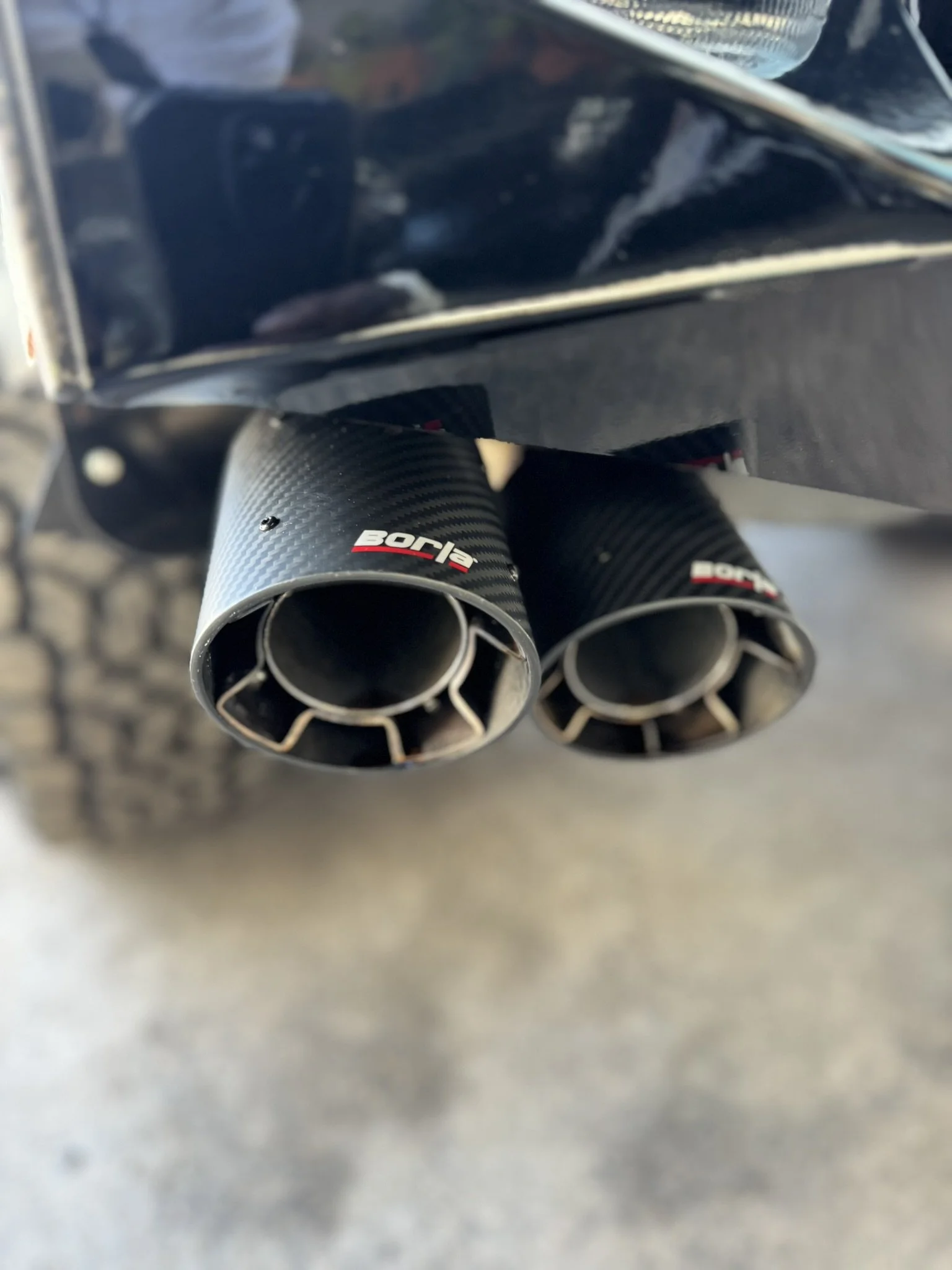 Close-up of dual Borla exhaust tips on a vehicle