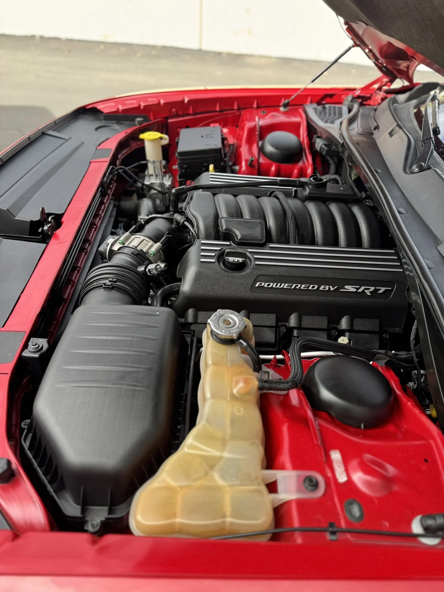Car engine bay with "Powered by SRT" engine cover