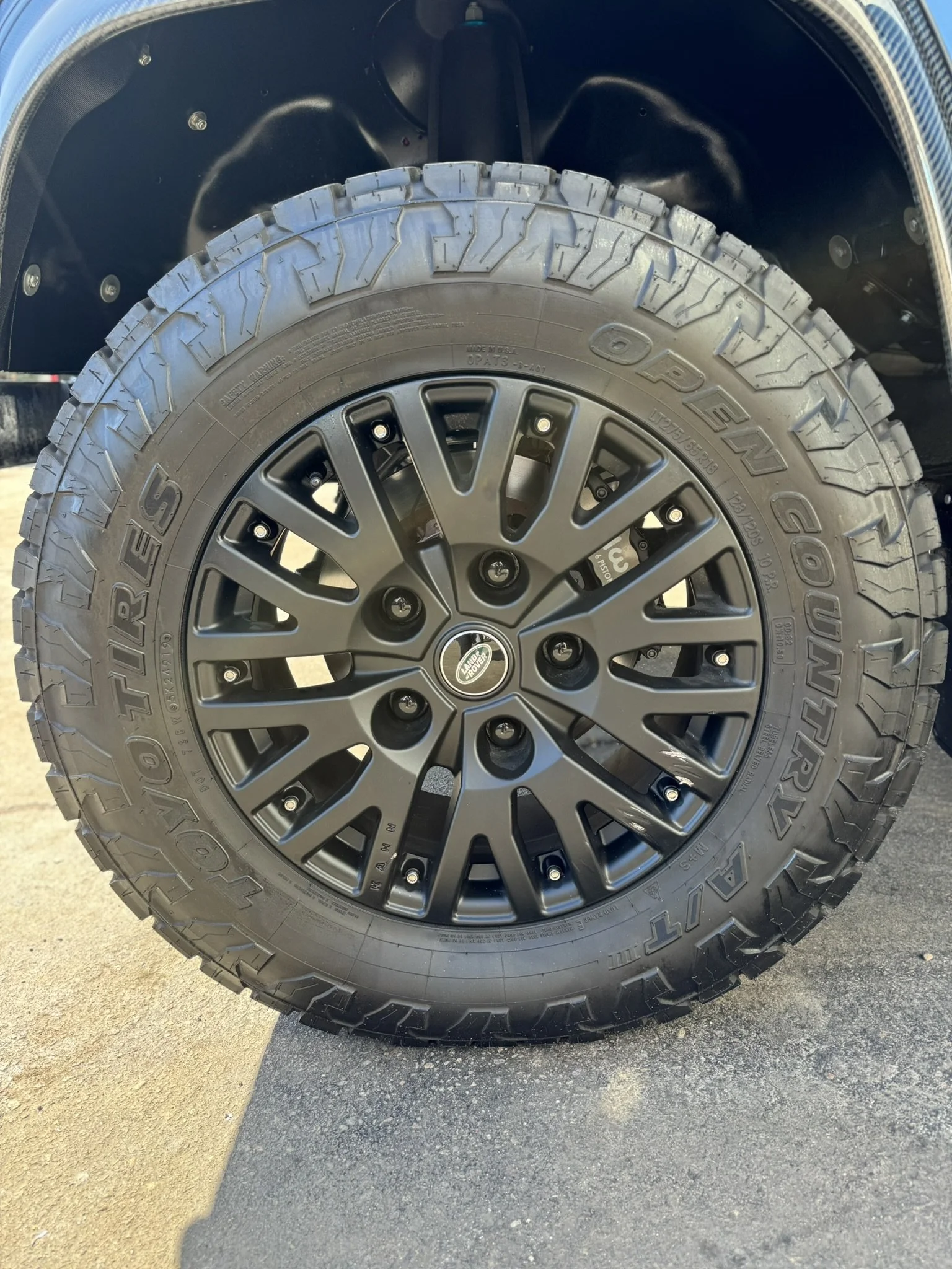 Close-up of a black alloy wheel with a Toyo Open Country A/T tire.