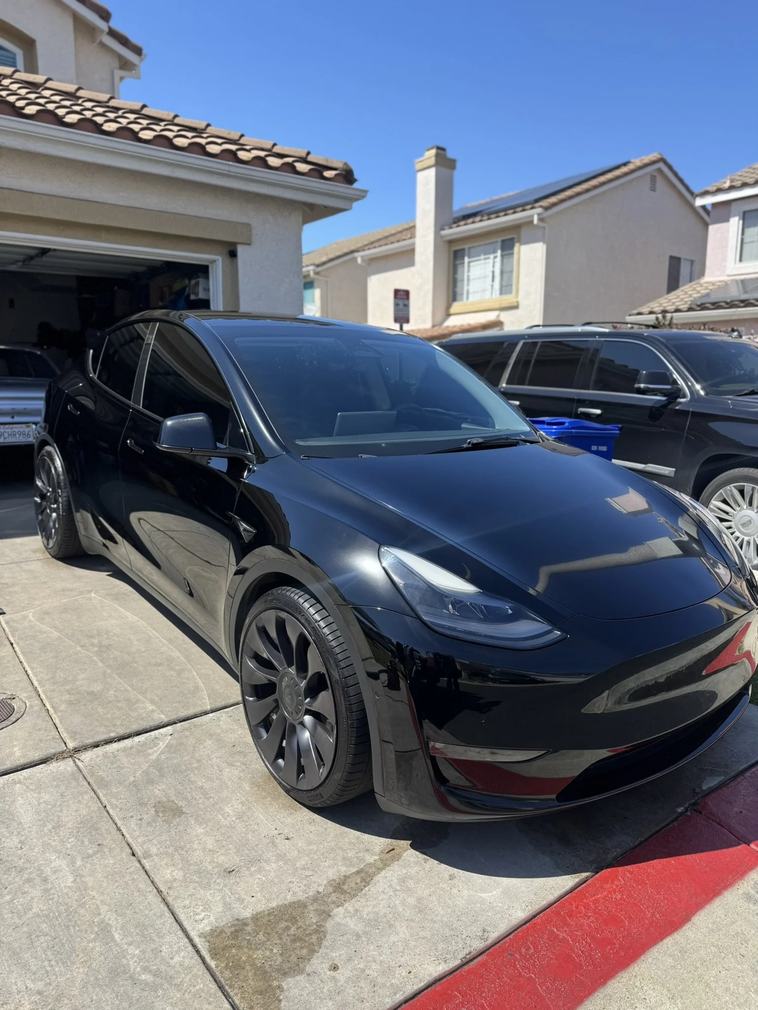 Black electric car withh flawless finish after professional detailing at Golden State Auto Wash & Detail