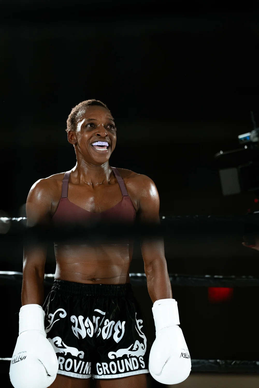 A fighter smiling in the ring between exchanges