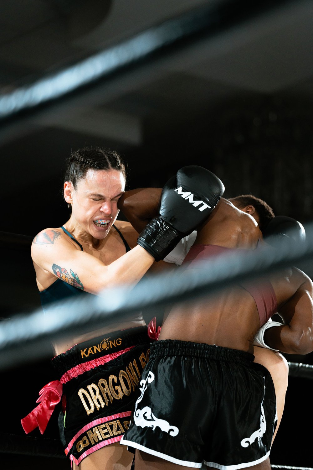 Two fighters trading in the clinch, an elbow landing