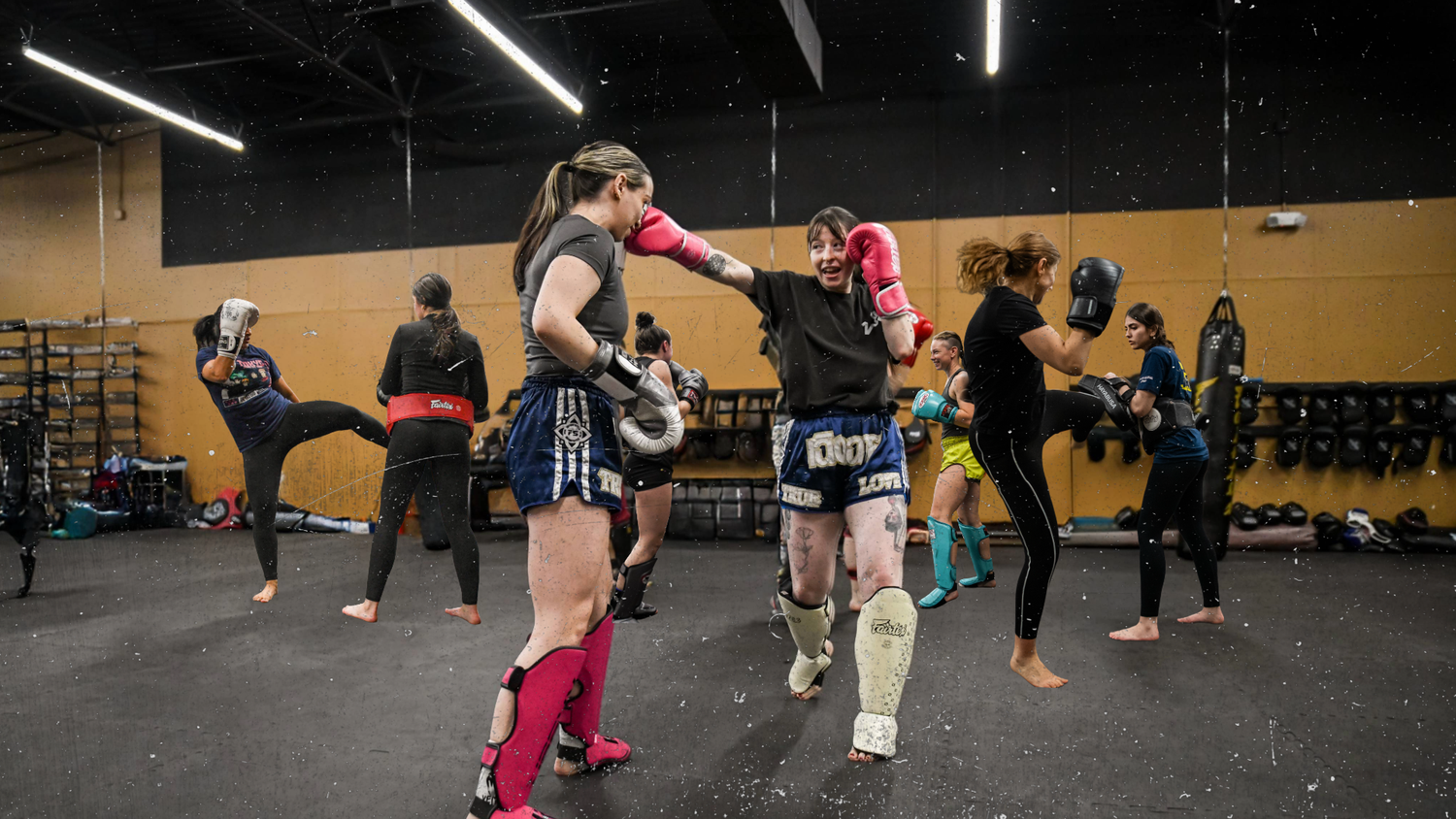 A member striking pads in a Women's Muay Thai class