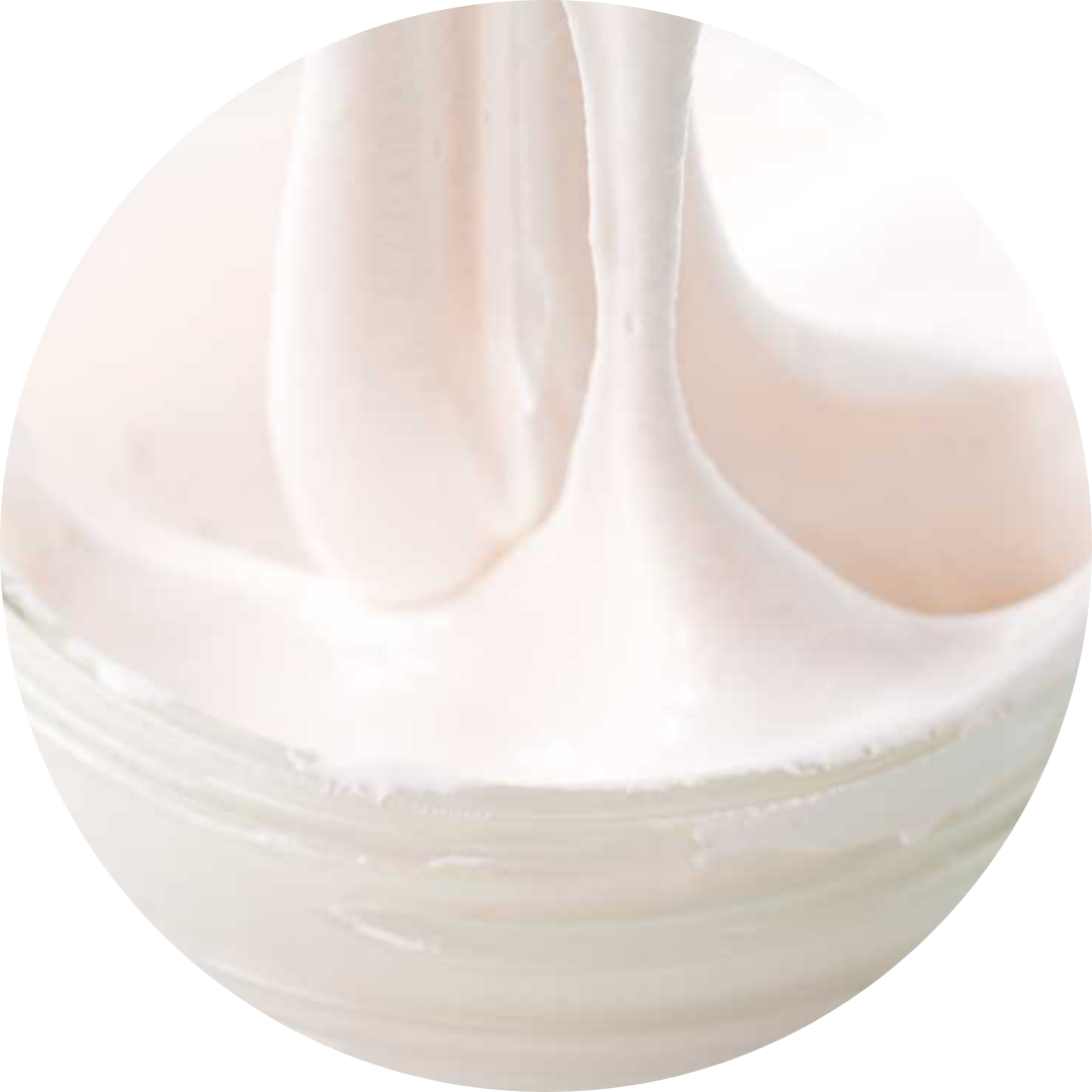 Close-up of whipped white cream in a bowl with soft peaks.