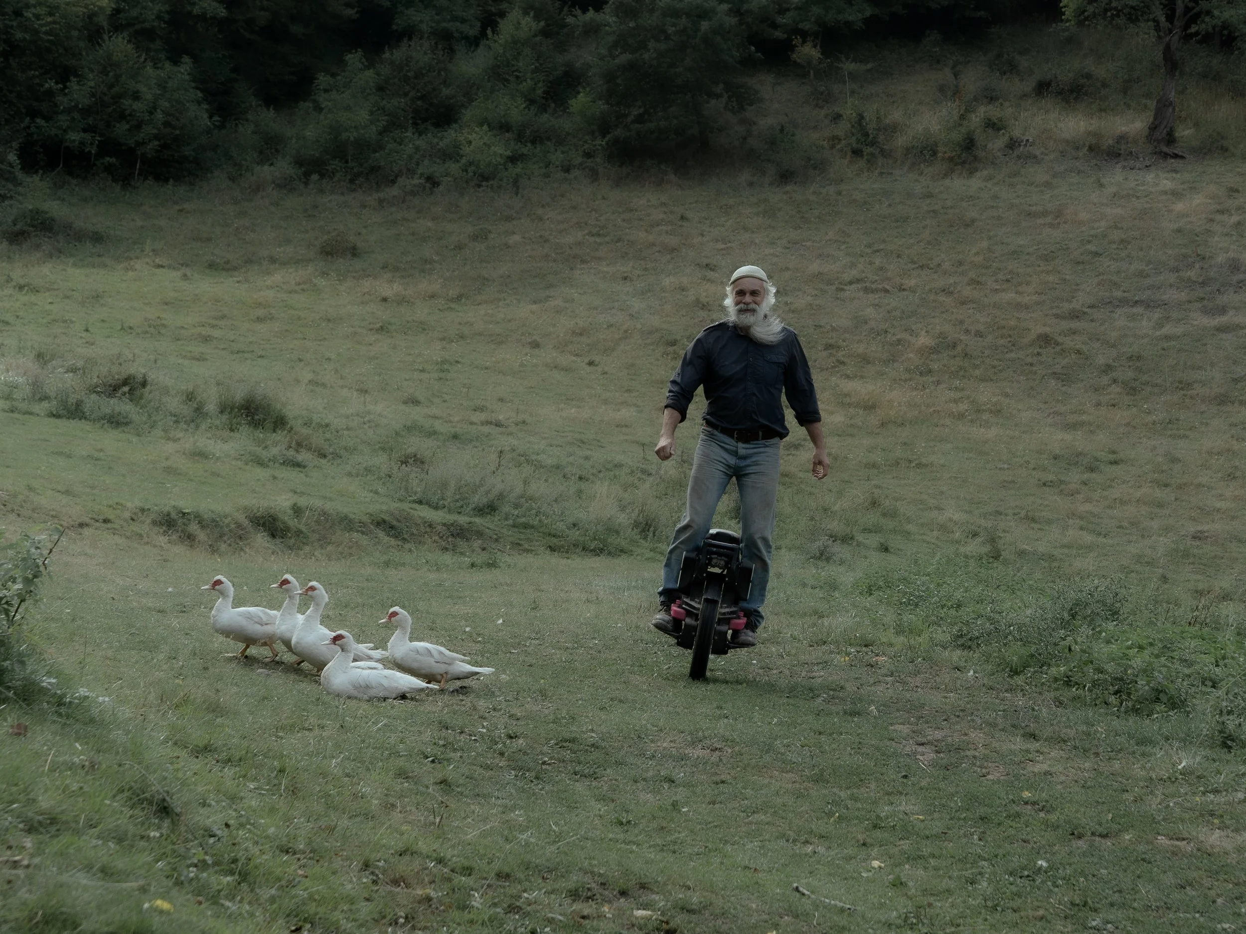 Vincent running errands on his unicycle. He is the father of the family who recently settled on the land below the farm.