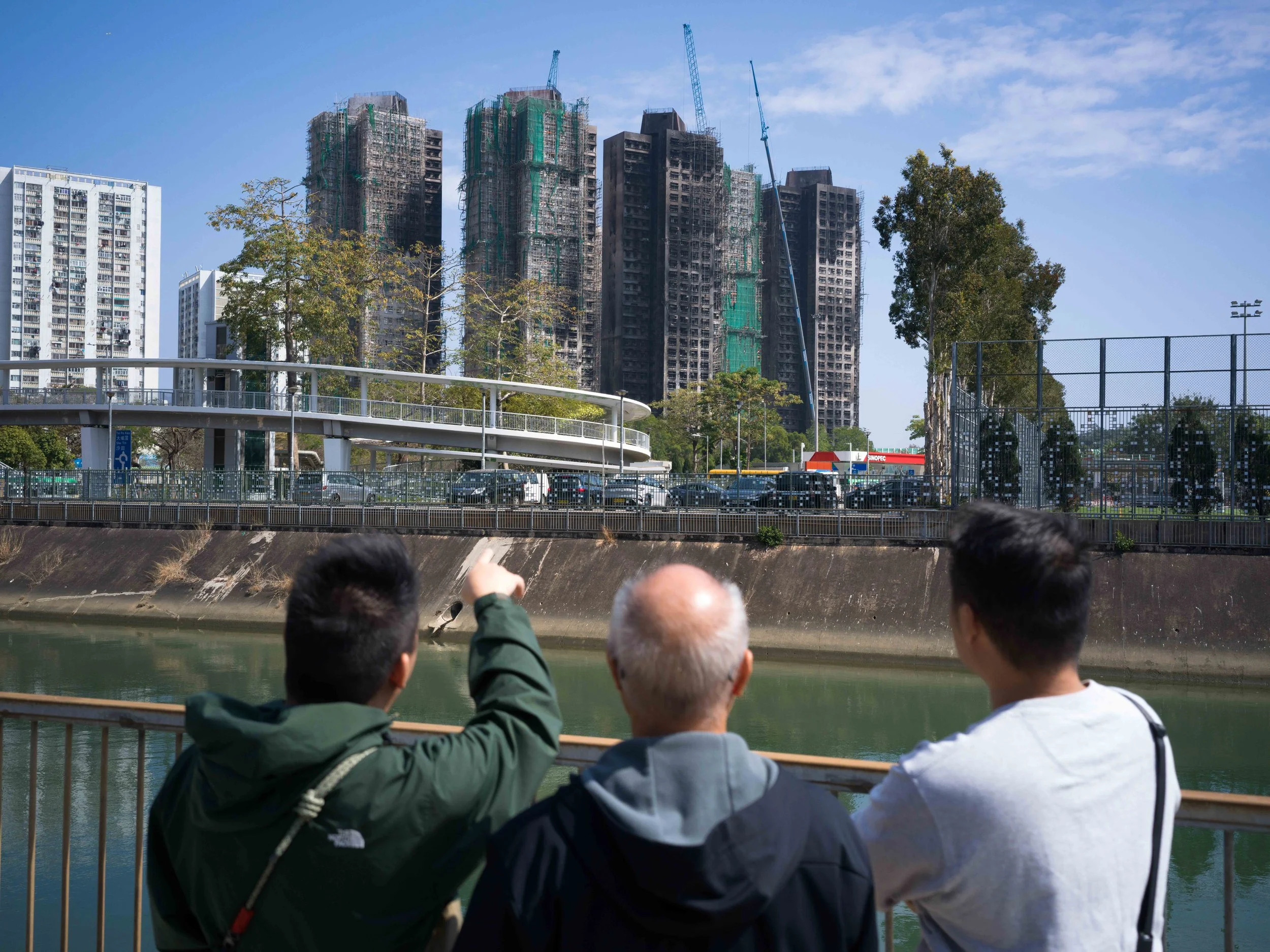 Yip Ka-kui (center) with his sons Sheun-ting (left) and Sheun-yin at Wang Fuk Court, Tai Po, Hong Kong, on February 4, 2026. 