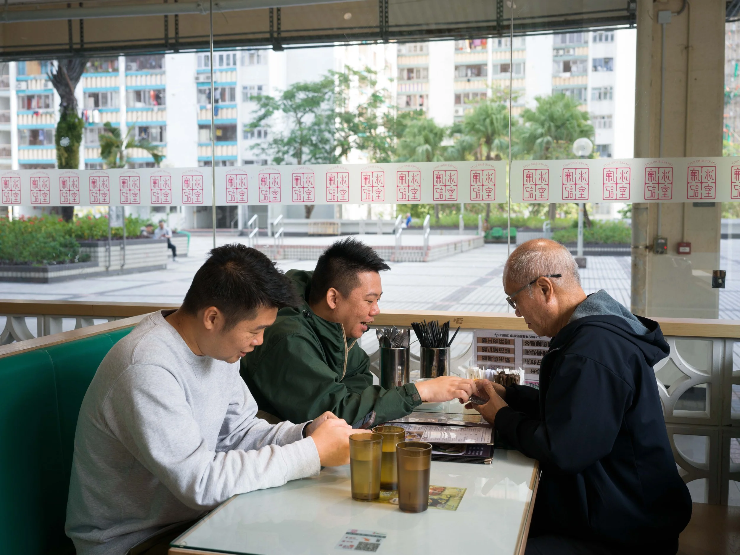 Yip Ka-kui and his younger son Yip Sheun-ting (center) are now living at the home of his older son, Yip Sheun-yin (left). 