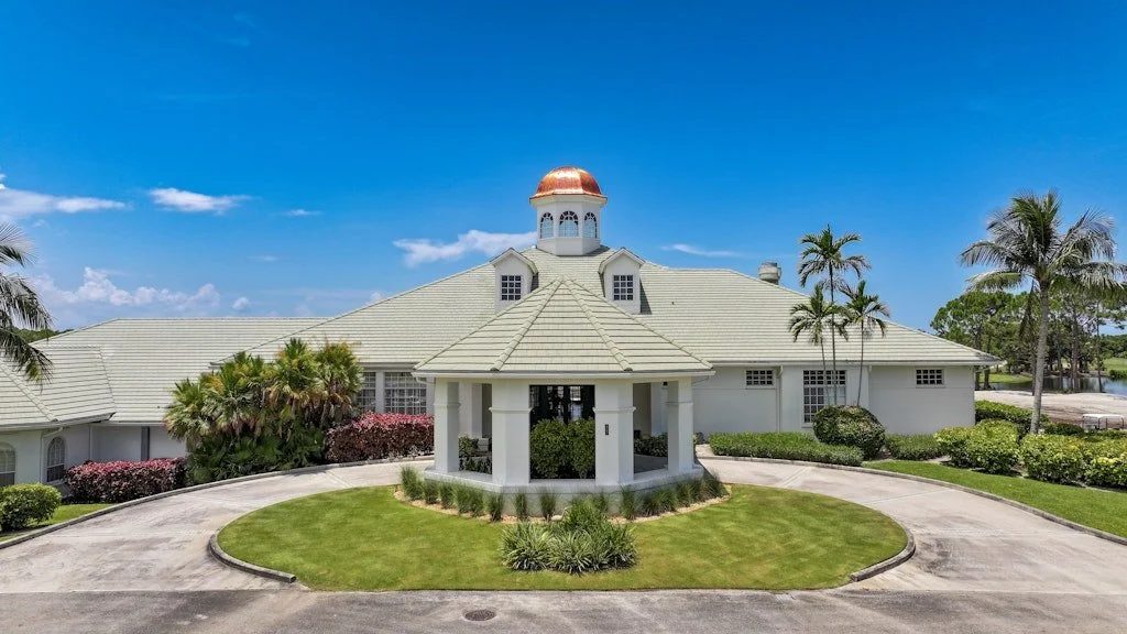 Clubhouse exterior at The Club at Lost Lake in Hobe Sound, Florida, with landscaped grounds.