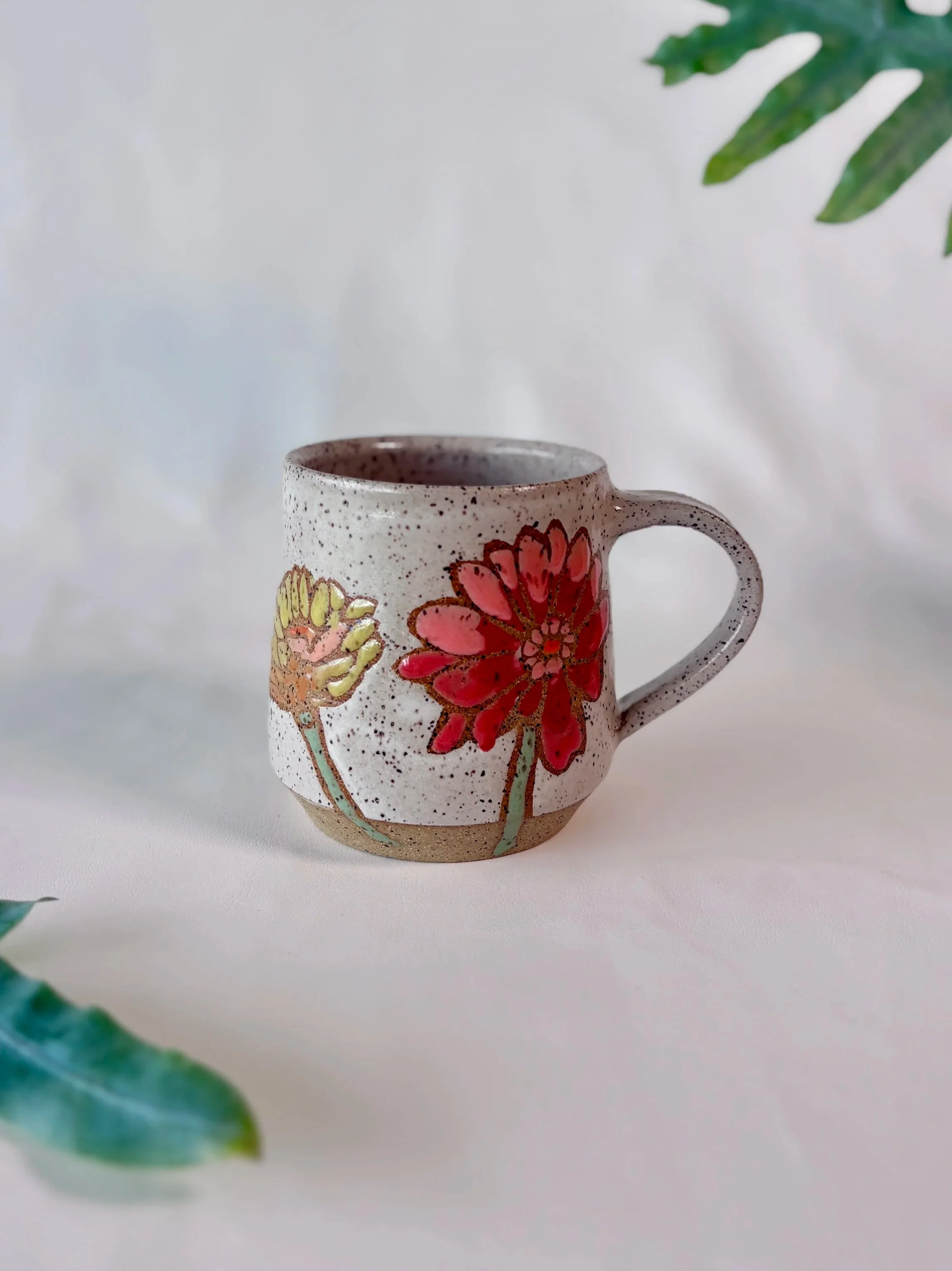 colorful zinnia flowers on a mug