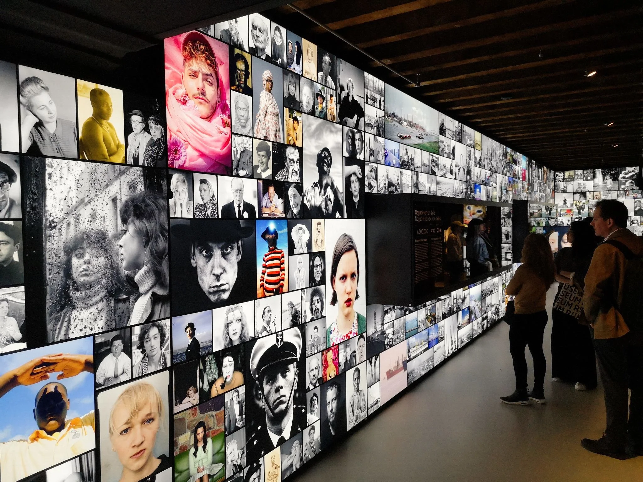 Large photo wall featuring grids of portrait photos in different sizes.