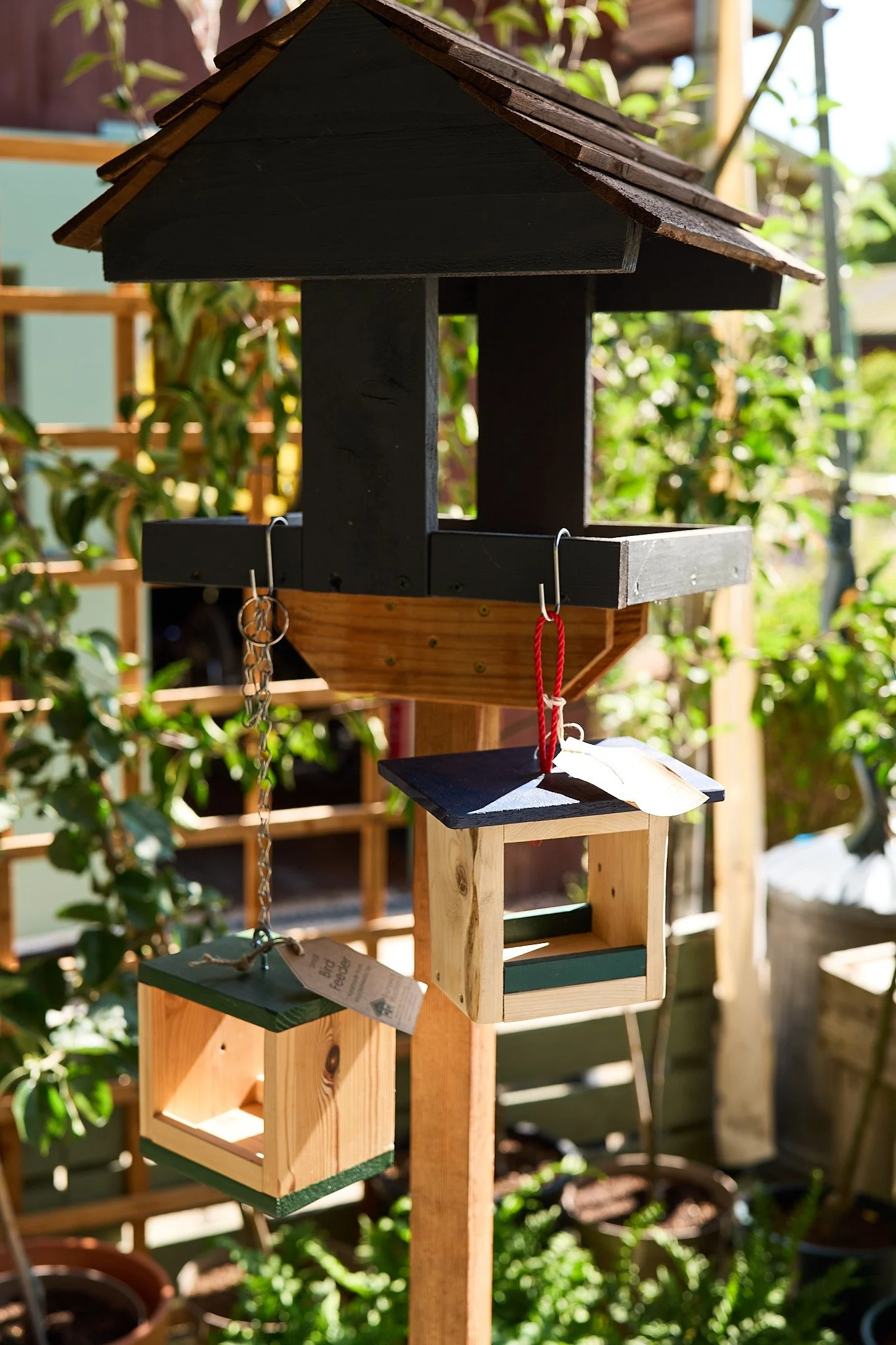 Handmade bird table with smaller bird boxes at Brunswick Organic Nursery.