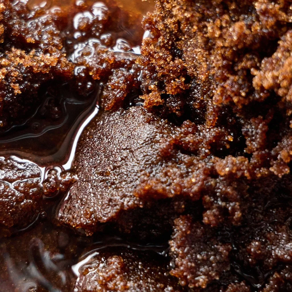 Brown sugar sitting sitting in a Kilner jar with gin and damsons.