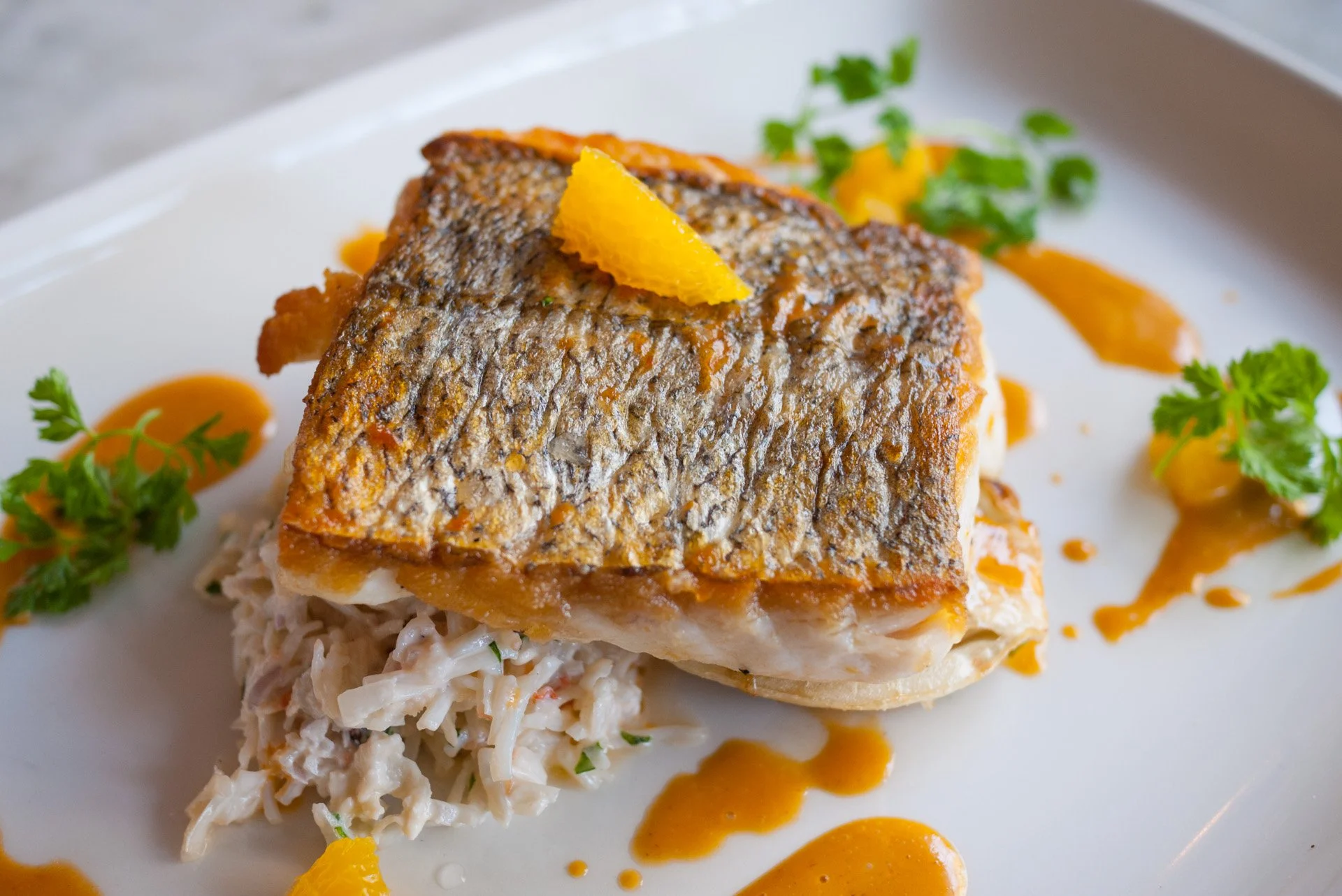 Close up of a dish of whitefish at the Drum and Monkey seafood restaurant in Harrogate, North Yorkshire.