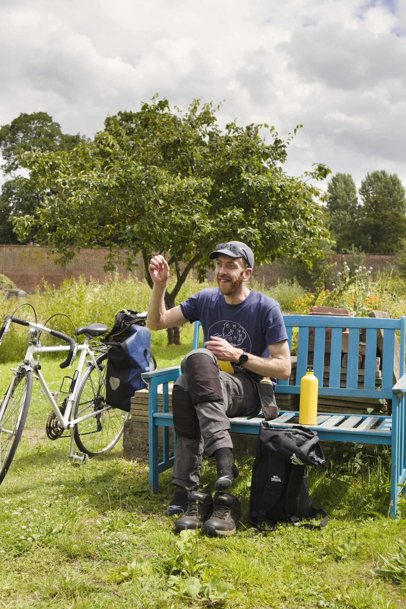 A man sitting on a bench in the Archbishop's walled garden in Bishopthorpe near York.