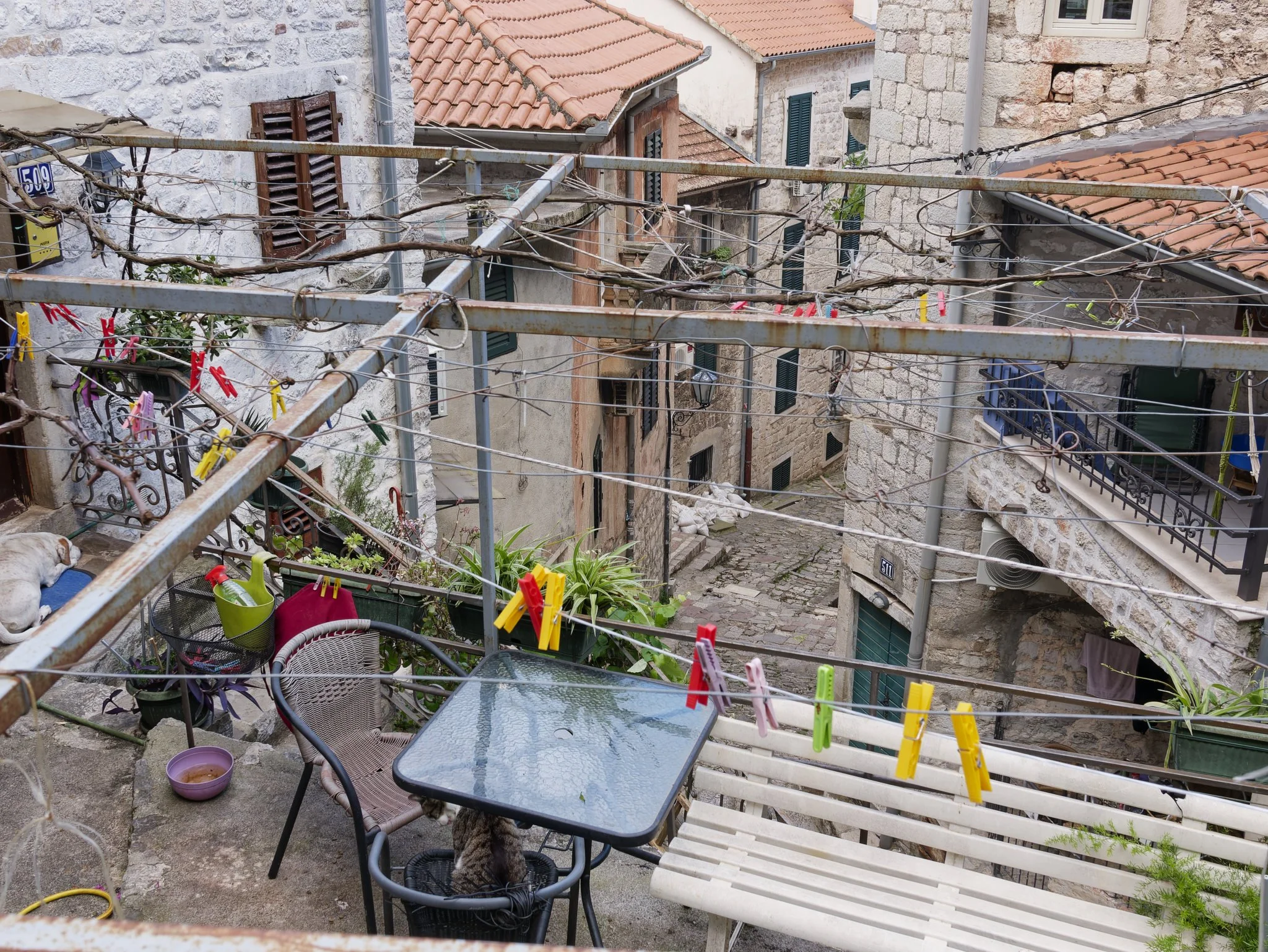 View of the tall buildings and narrow streets in Kotor from a garden with washing line.