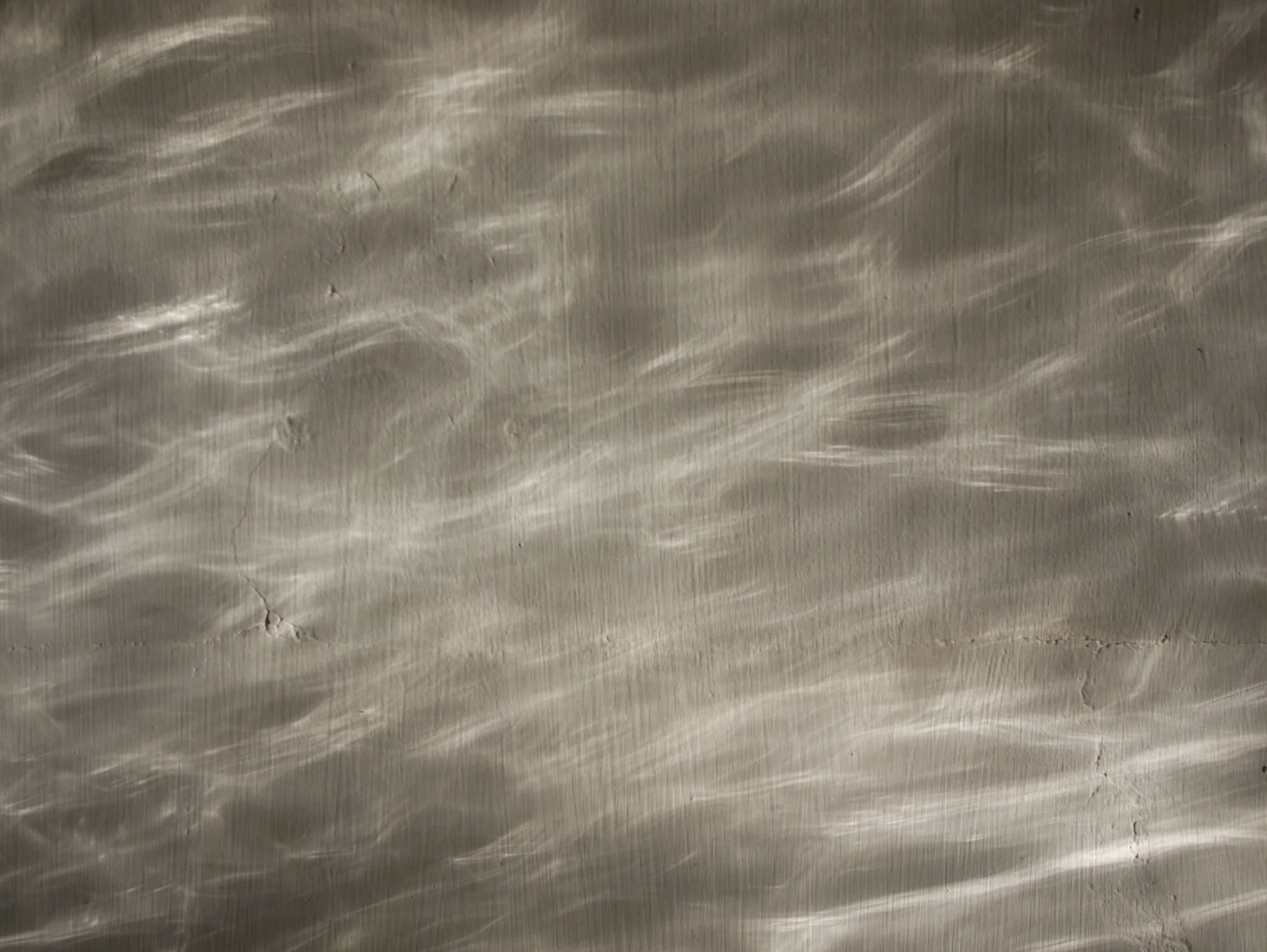 Caustic window reflections cast over a light grey wall.