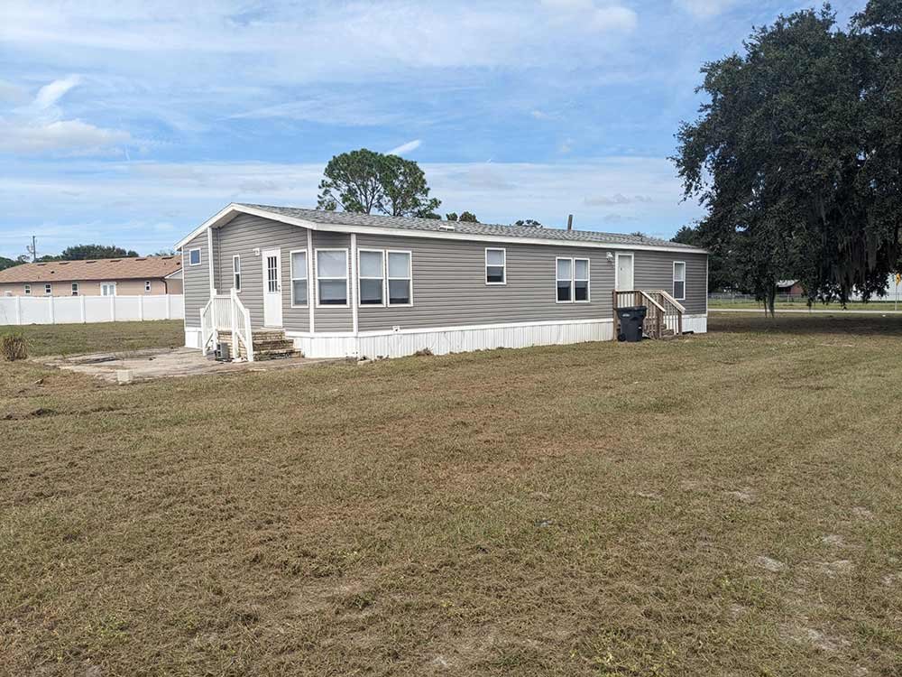 Gray mobile home on a large lot