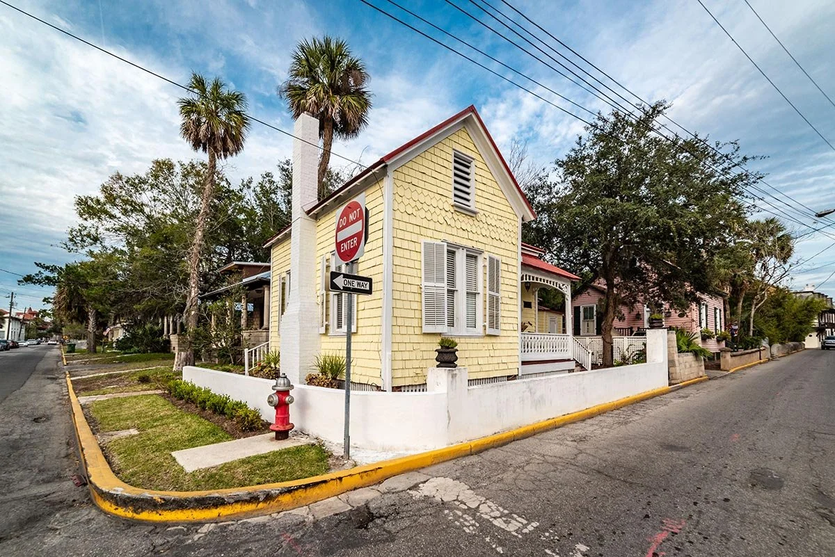 An older yellow Florida home with visible wear, representing homes affected by stricter insurance requirements.