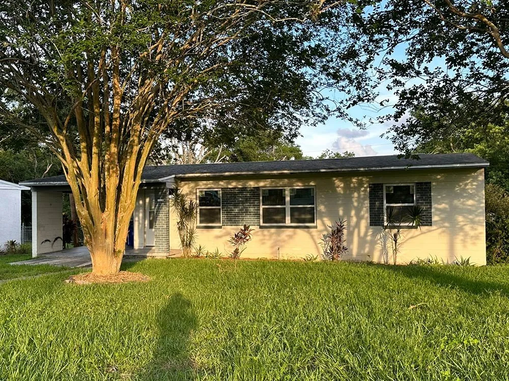 Ranch home with a large tree in the front yard