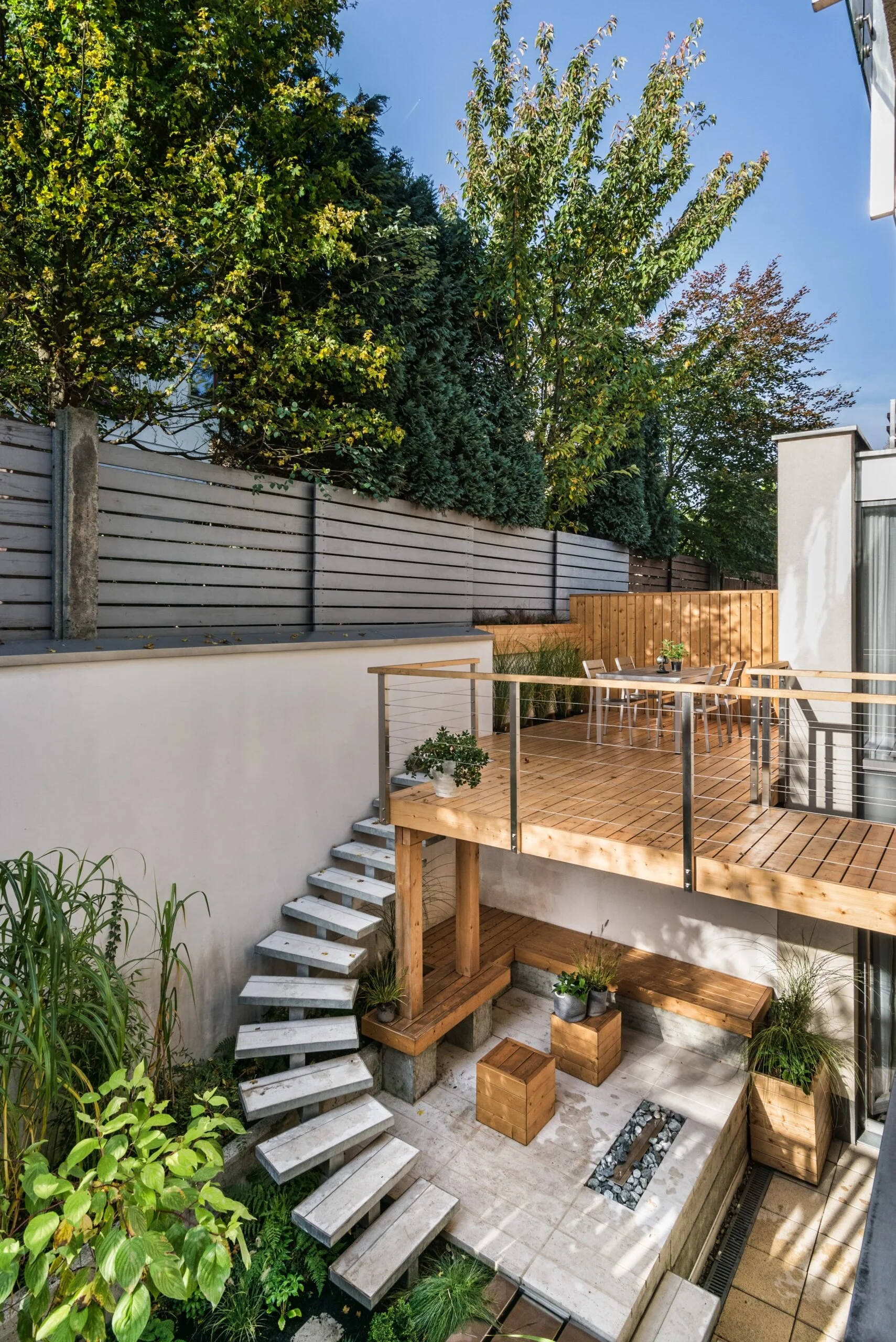 Rooftop garden with cedar decking, fencing, benches, and planter boxes.
