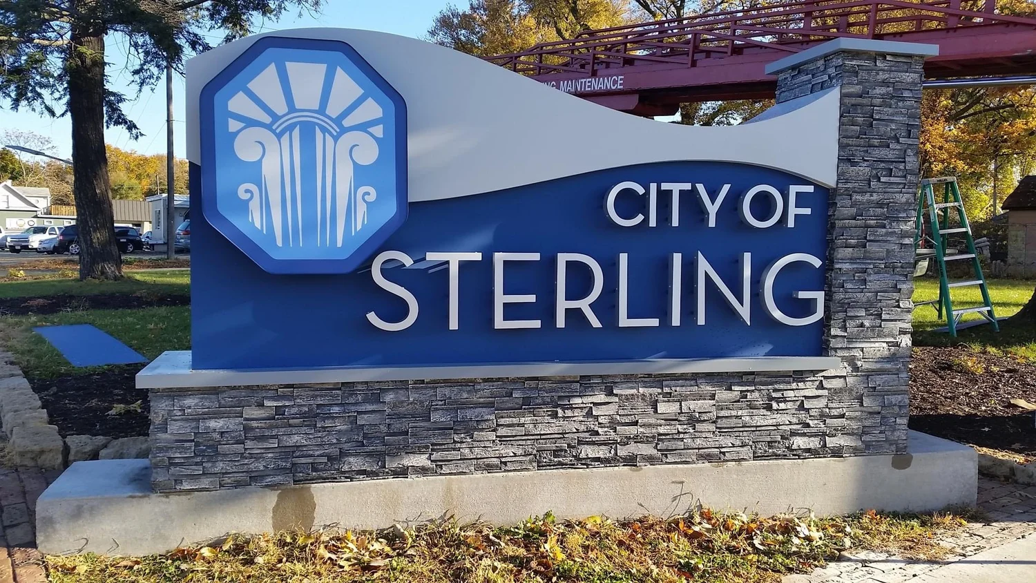 City of Sterling monument sign with a blue background and white architectural motif