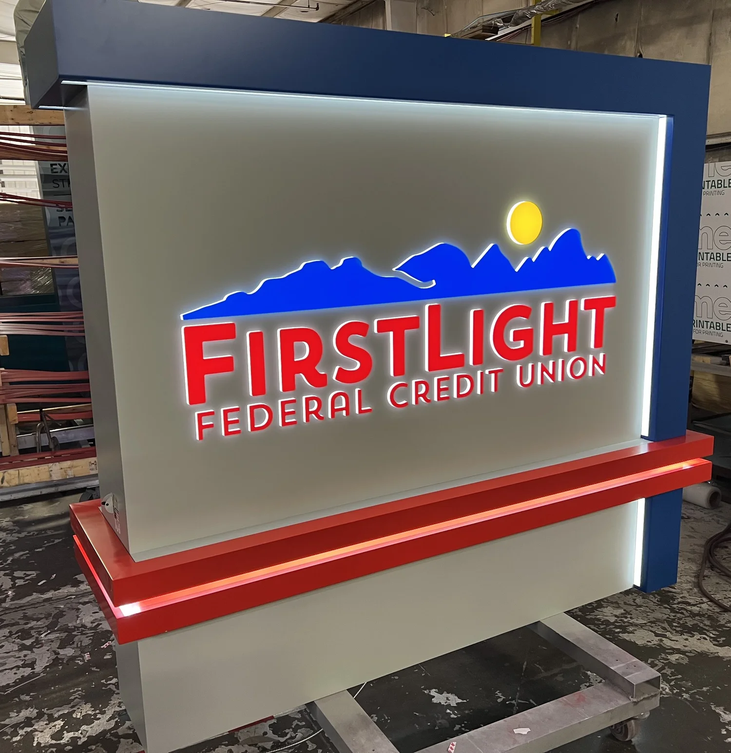 Illuminated First Light Federal Credit Union monument sign