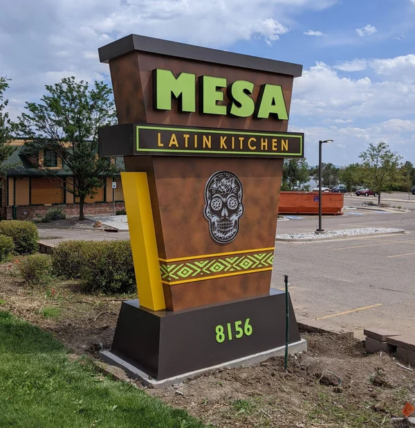 Mesa Latin Kitchen monument sign with skull design and address 8156