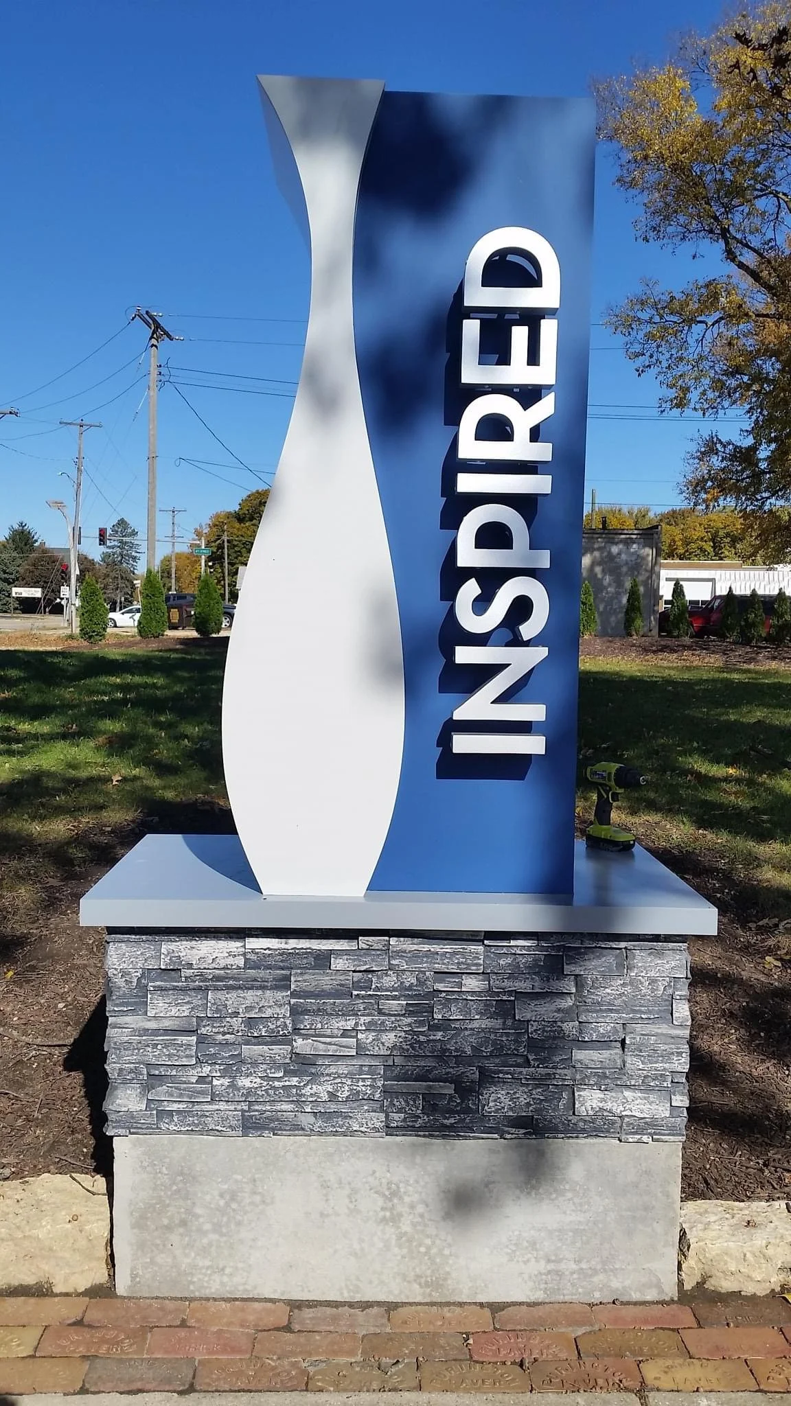 NspireD monument sign mounted on a stone and concrete base