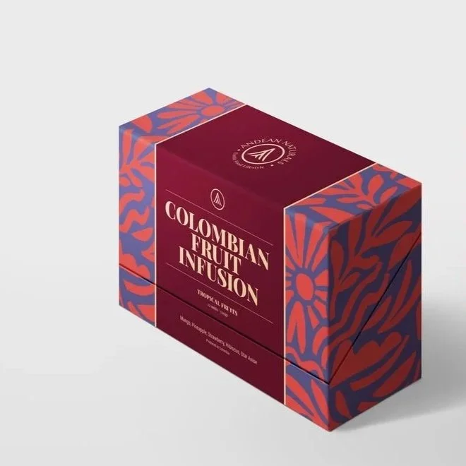 A cardboard box packaging with a purple and orange design, labeled 'Colombian Fruit Infusion' with a logo at the top and containing tropical fruit infusions.