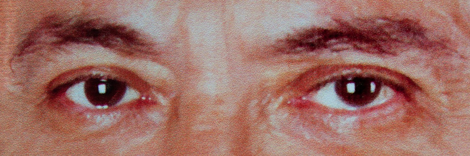 A photo of the eyes of a politician from their election campaign poster