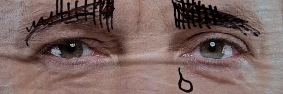 A photo of the eyes of a politician from their vandalized election campaign poster