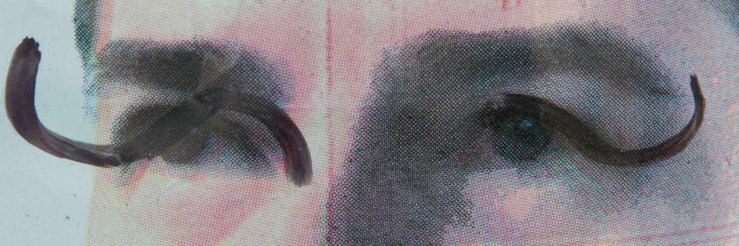 A photo of the eyes of a politician from their vandalized election campaign poster