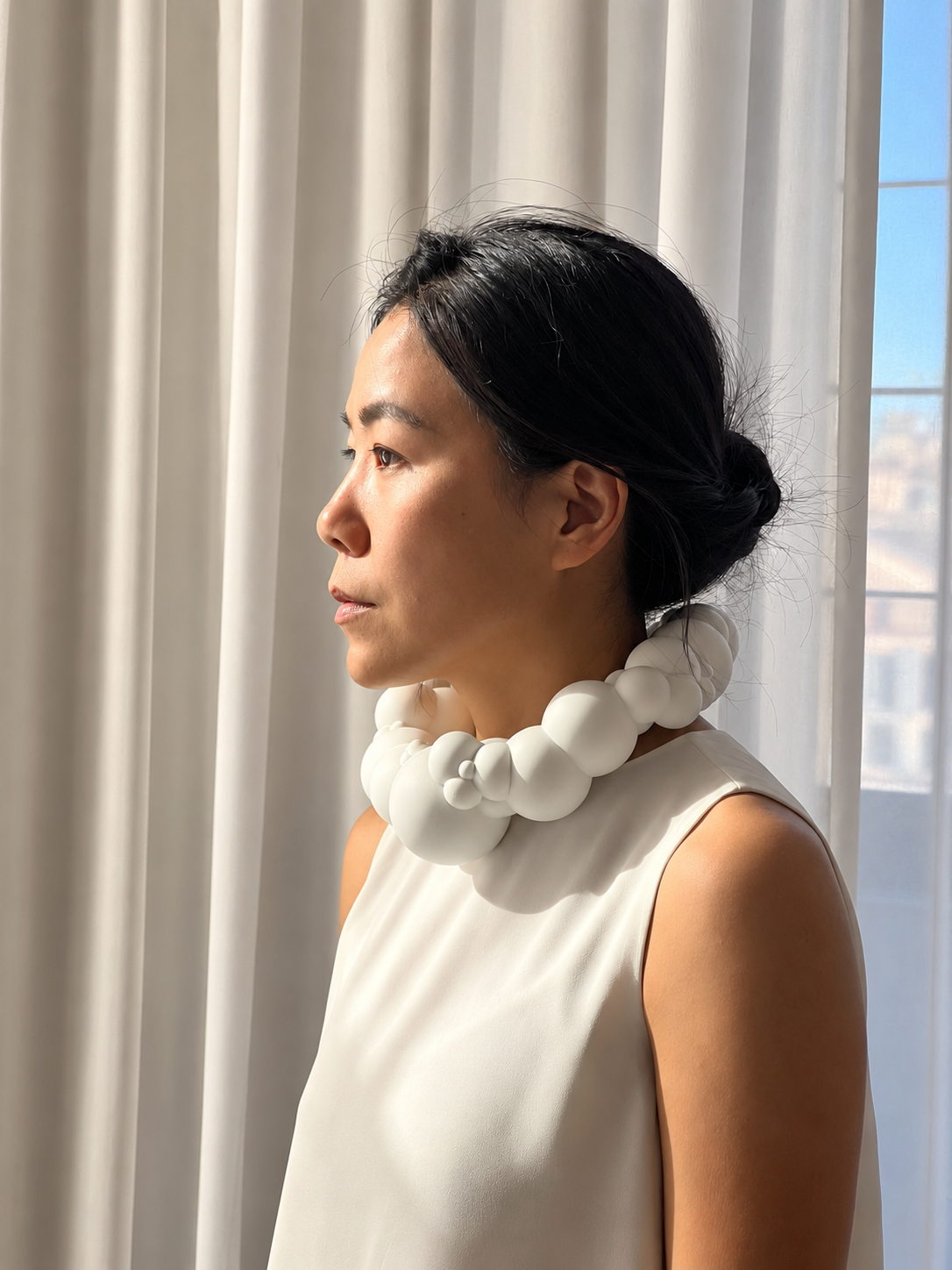 Contemplative Profile with Sculptural Necklace.png