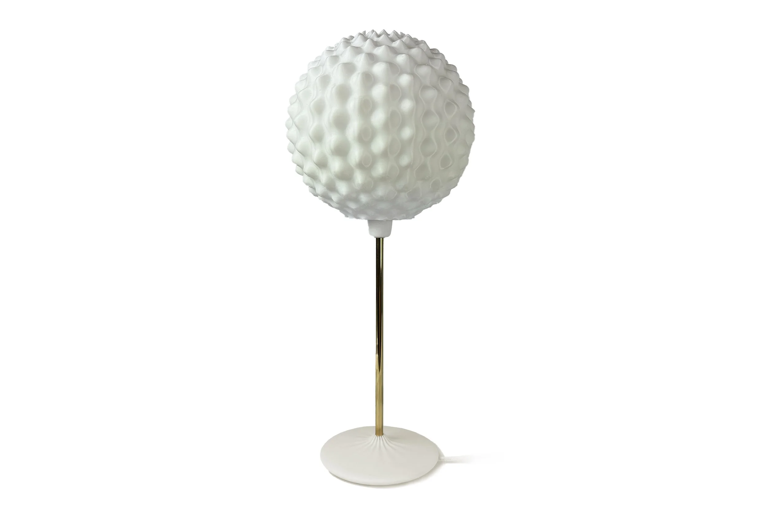 A modern table lamp with a textured white globe and a gold stem on a white circular base.