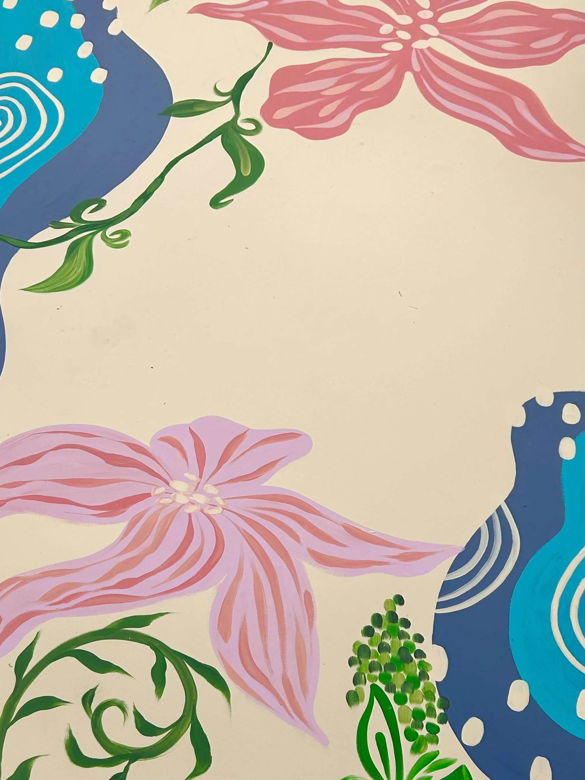 Close-up of a tropical floral mural featuring large pink flowers with striped petals, green vines, and blue accents with white circular patterns.