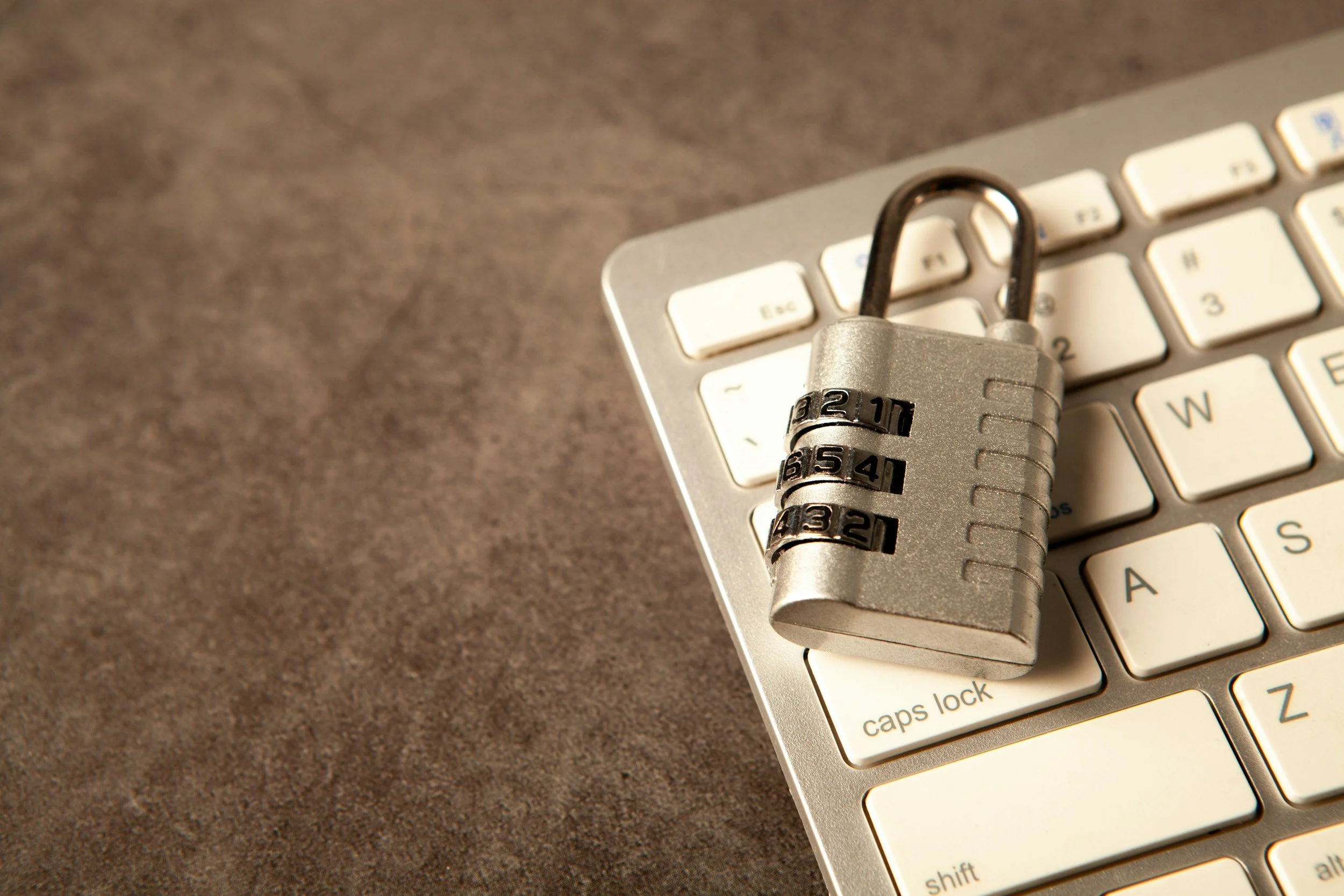 A padlock and a globe representing global cybersecurity on a circuit board with digital data in the background.