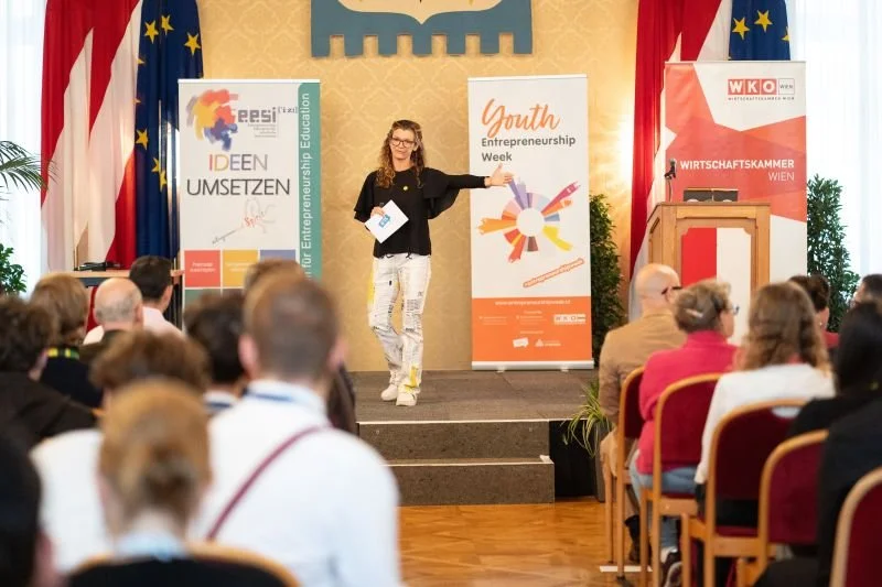 Regine Eitelbös spricht auf der Bühne zum Publikum beim Entrepreneurship4Youth Festival des Vereins IFTE über Female Entrepreneurship.